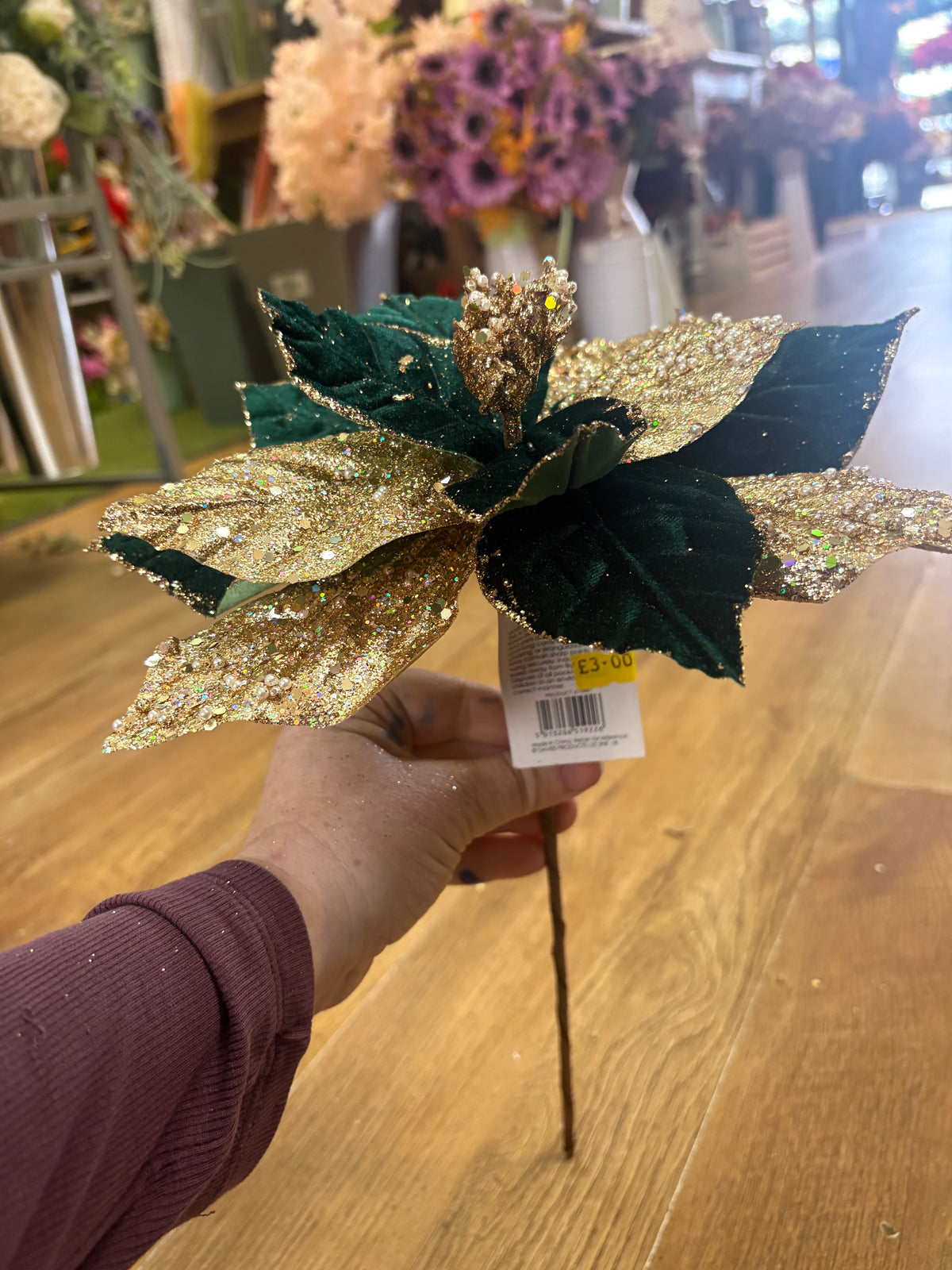 Short stem green velvet and gold glittered poinsettia with pearls
