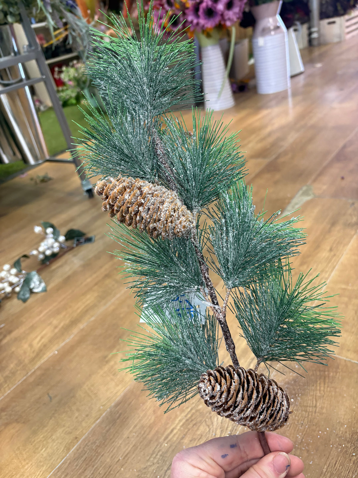 Long stem frosted and glittered winter foliage with cones