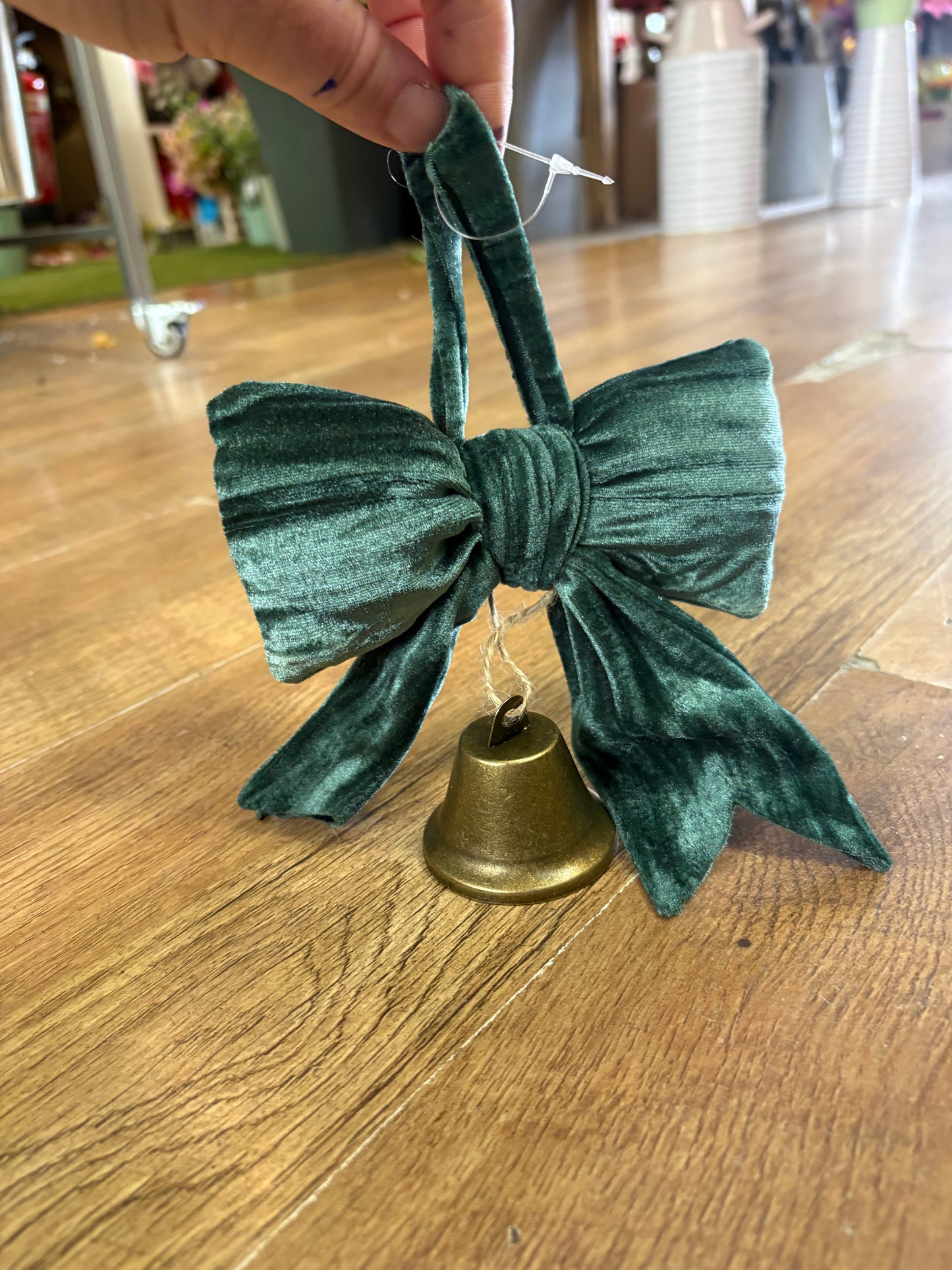 Small hanging green velvet bow and Christmas bell