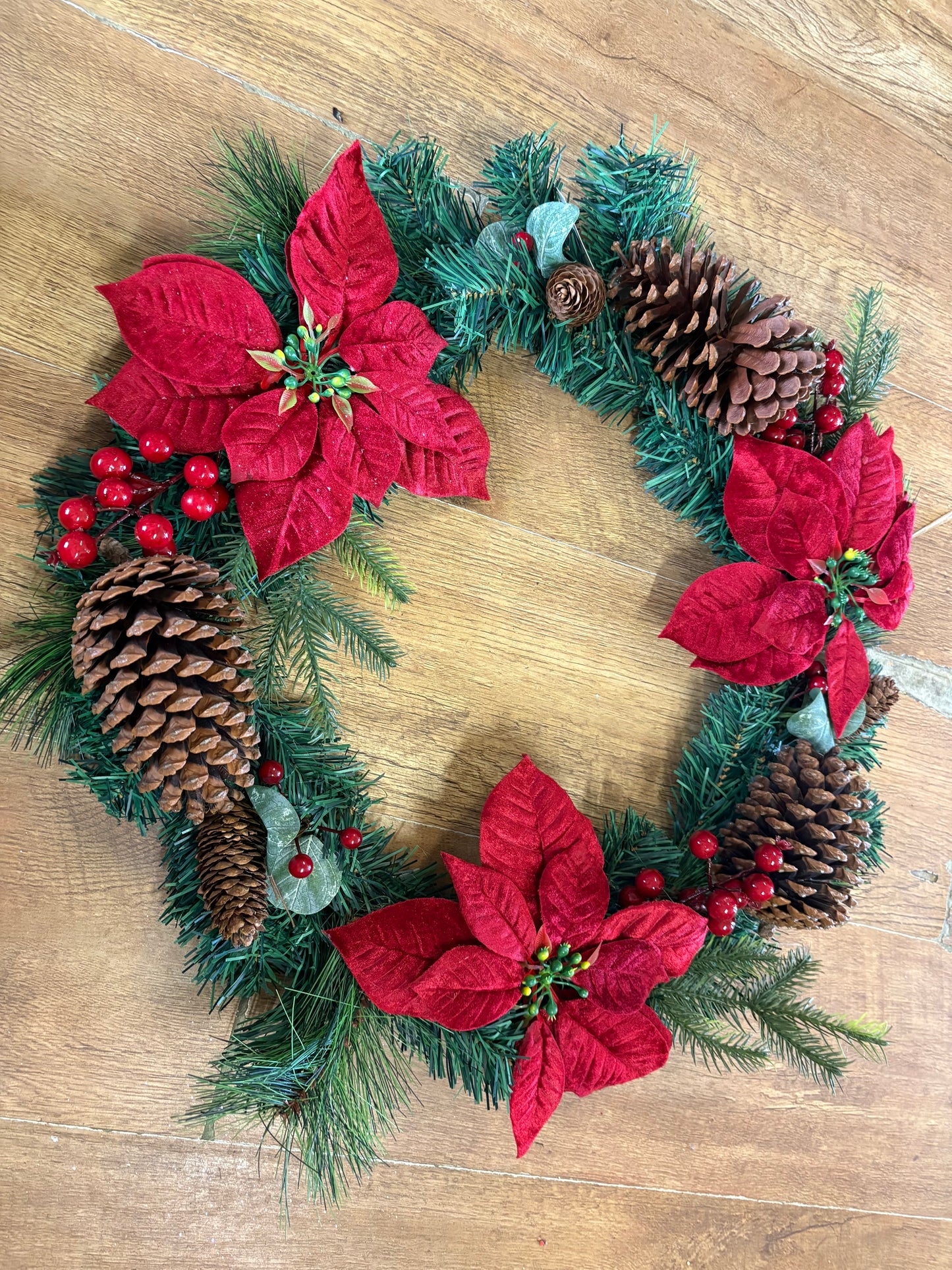 Poinsettia and red berry wreath (55cm from tip to tip)