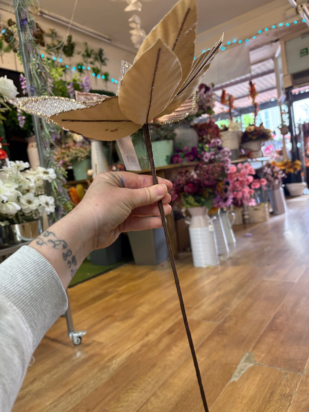 Large rose gold metallic and glittered single long stem poinsettia