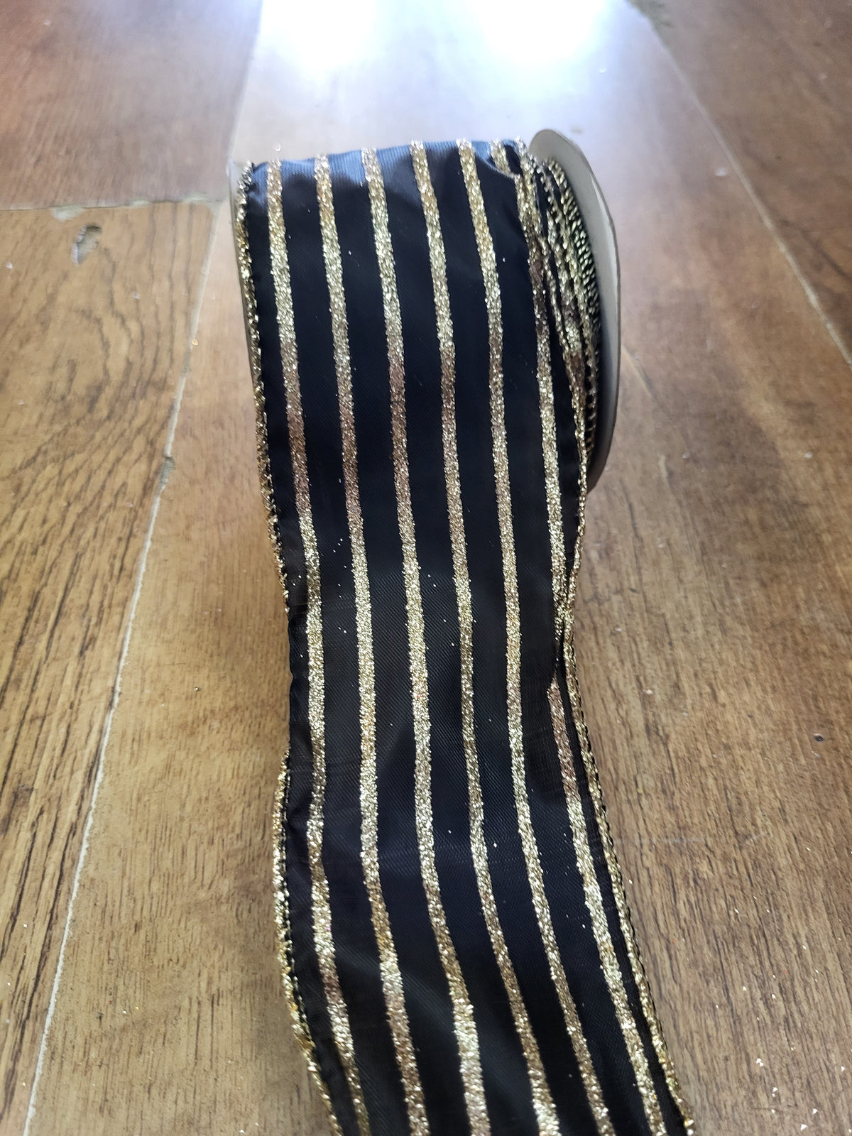 2.7m approx. roll of black with gold glitter striped wired ribbon image 0