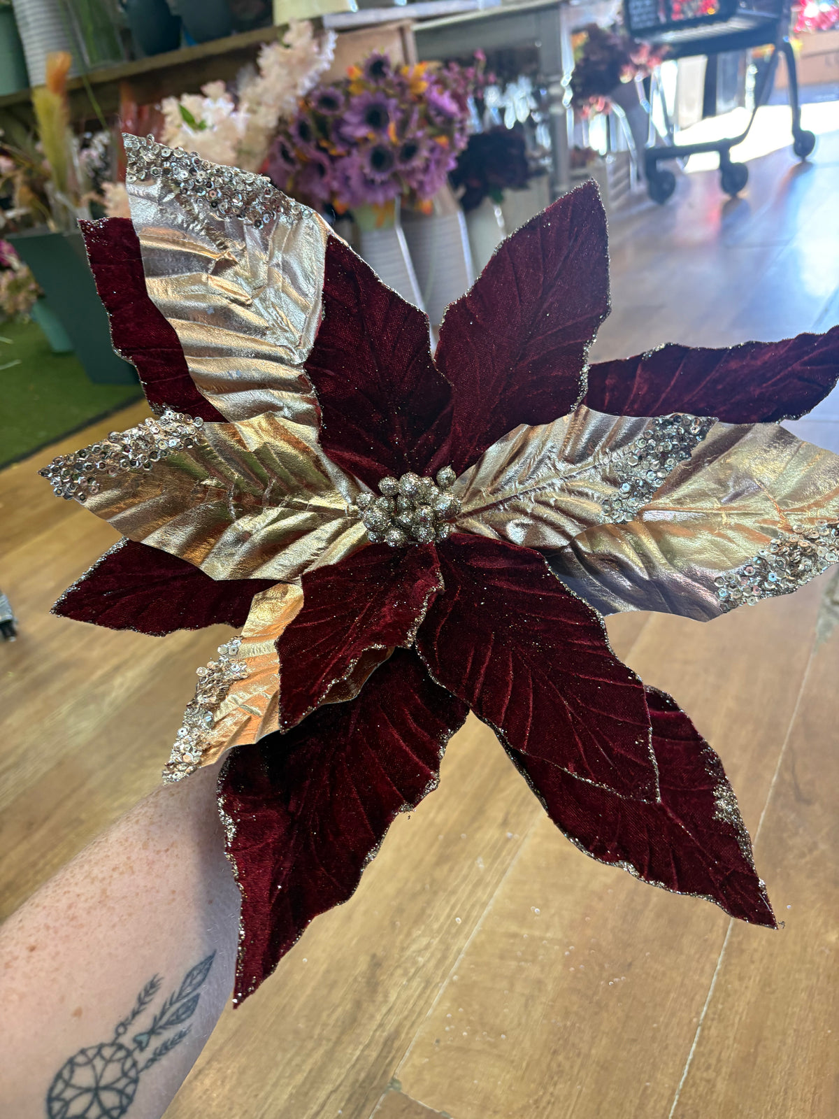 Large burgundy velvet and metallic gold poinsettia
