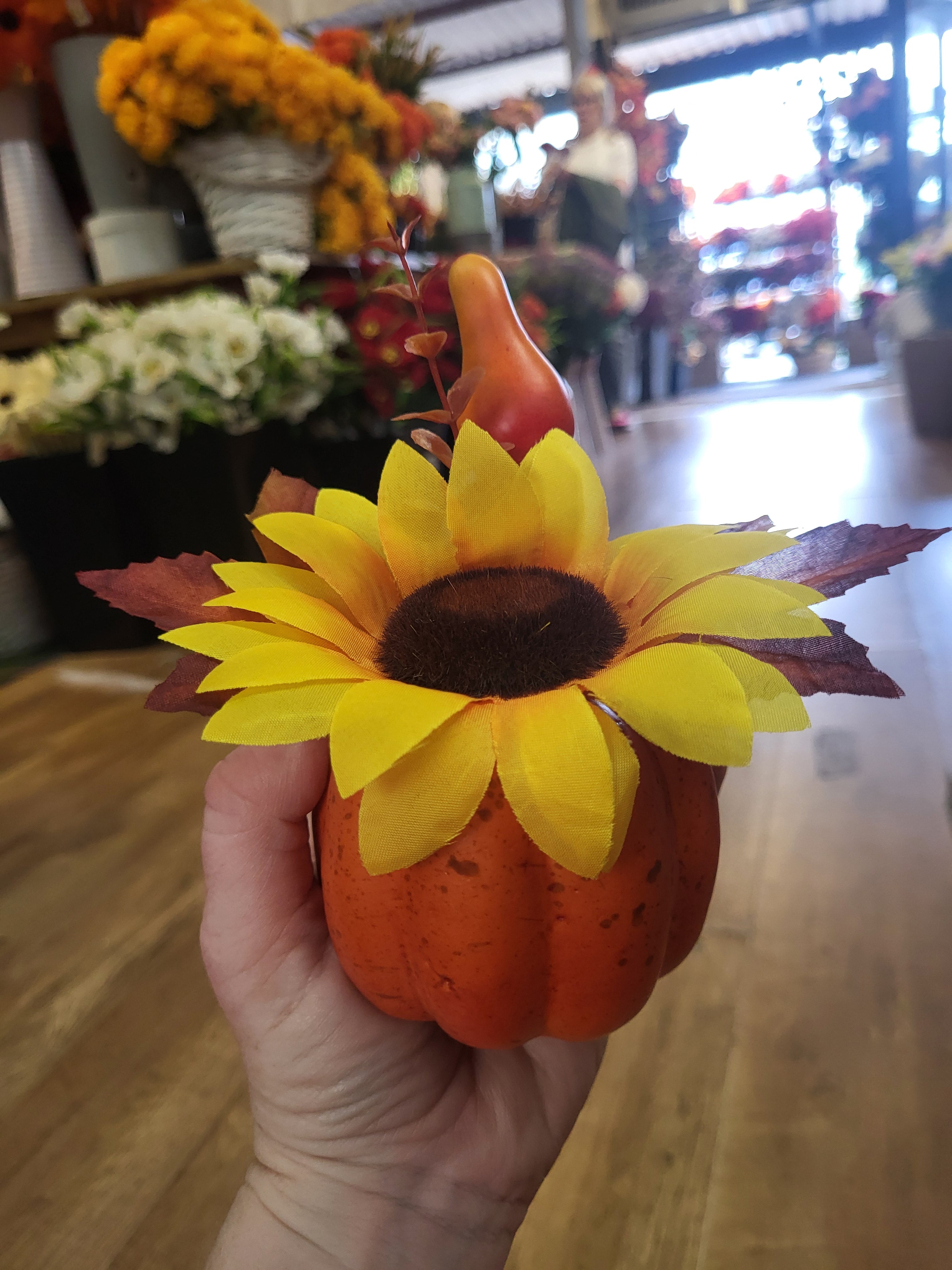 Small decorated pumpkin with yellow flower image 0