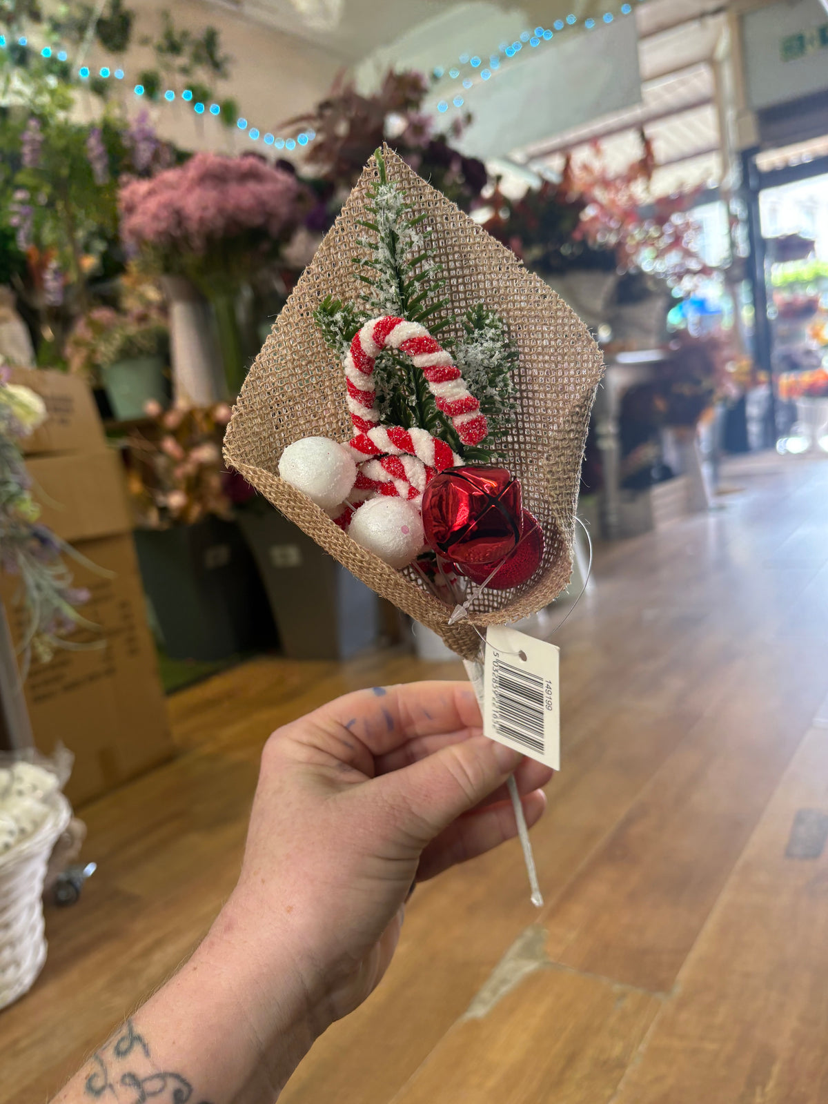 Candy cane and bell pick wrapped in hessian