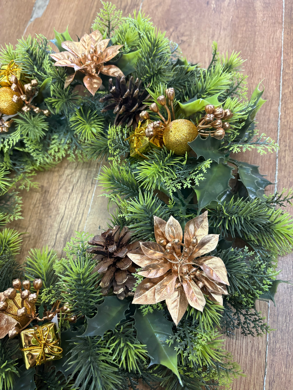 18”  wreath with gold poinsettias, cones, gifts and glitter balls