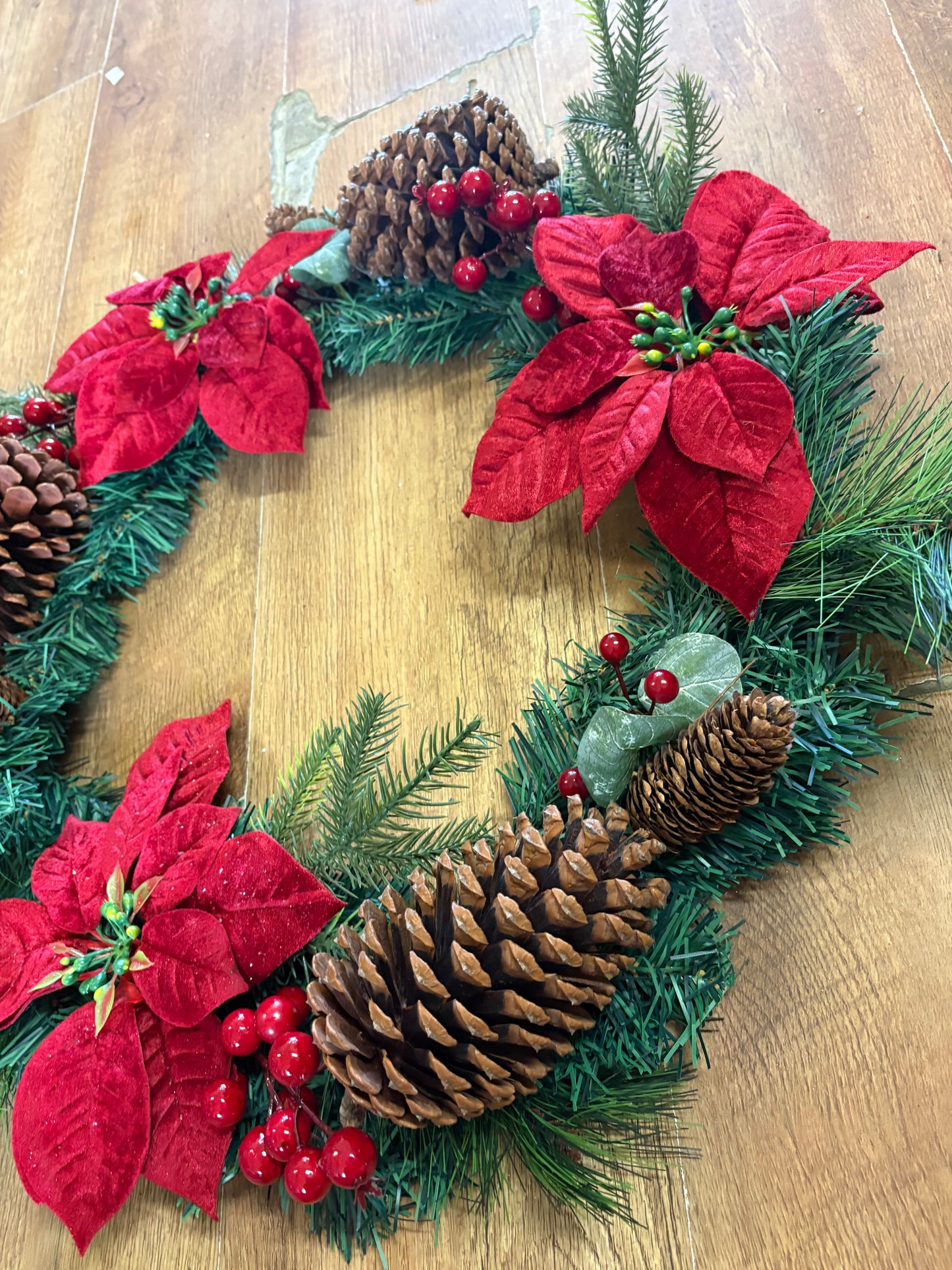Poinsettia and red berry wreath (55cm from tip to tip)