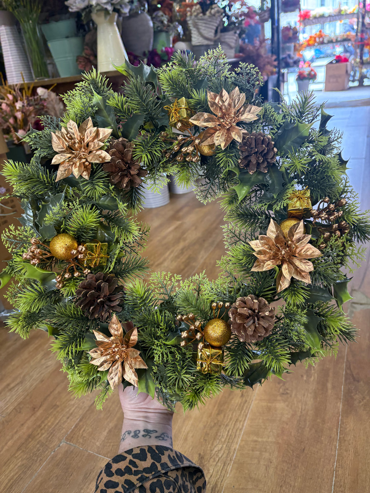 18”  wreath with gold poinsettias, cones, gifts and glitter balls