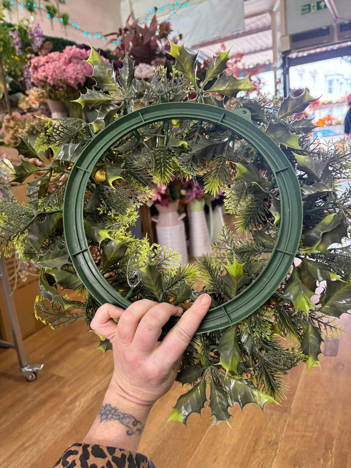 18”  wreath with gold poinsettias, cones, gifts and glitter balls