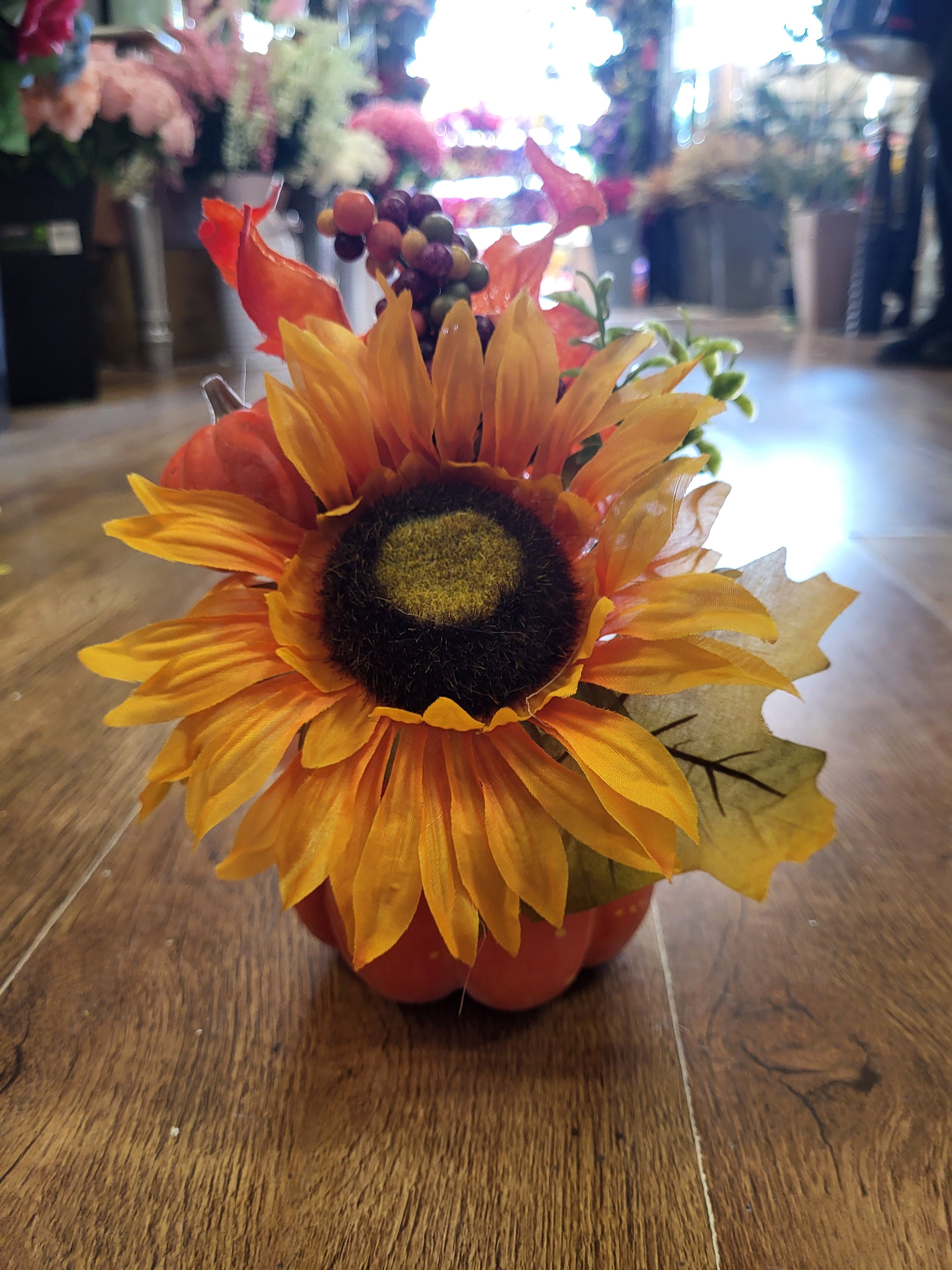 Sunflower/berry/foliage in pumpkin display  image 1