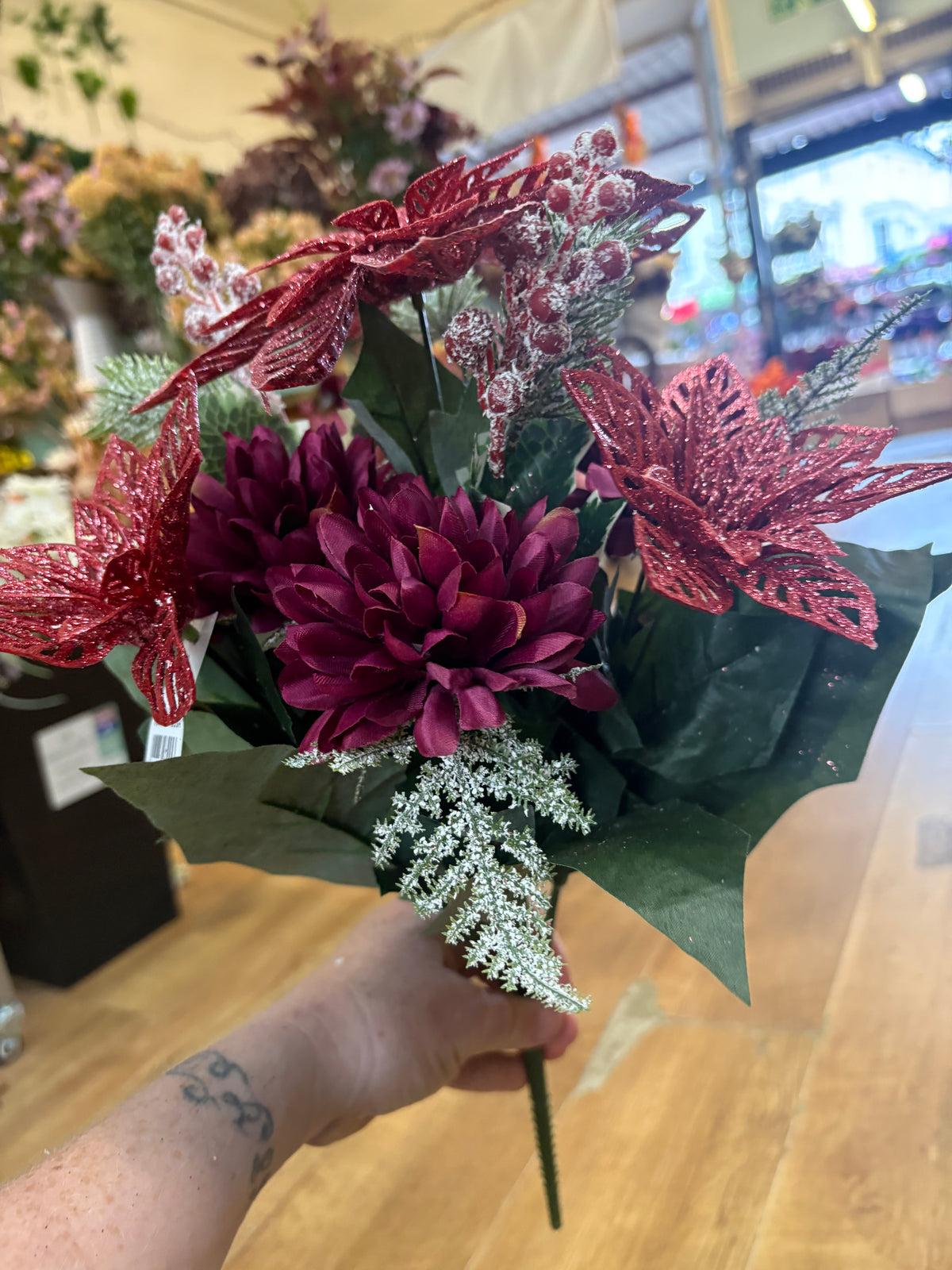 Pink glittered poinsettia and purple chrysanthemum bouquet