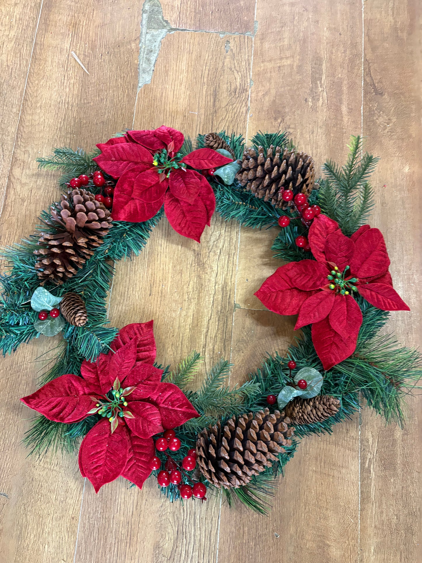 Poinsettia and red berry wreath (55cm from tip to tip)