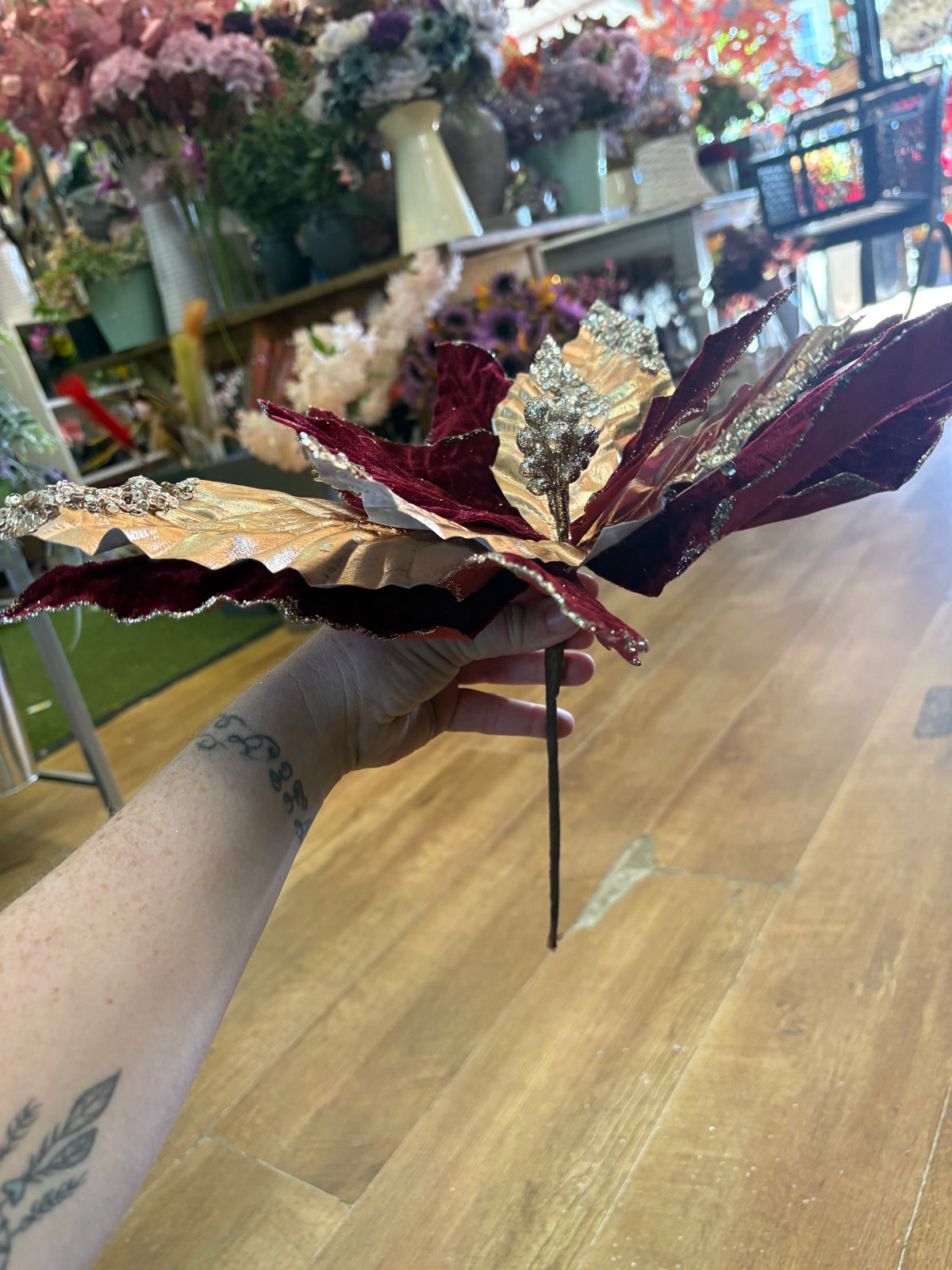 Large burgundy velvet and metallic gold poinsettia