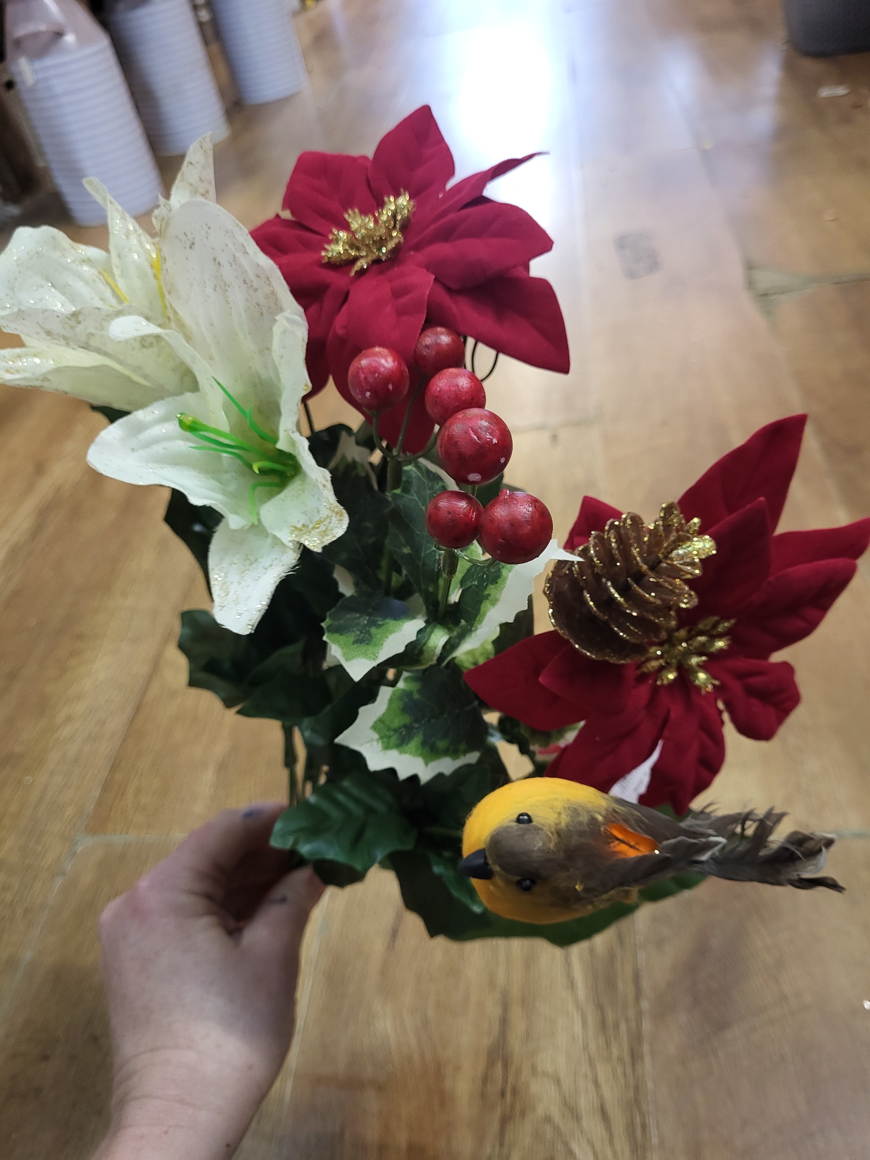 Poinsettia, lily and robin bouquet  image 1