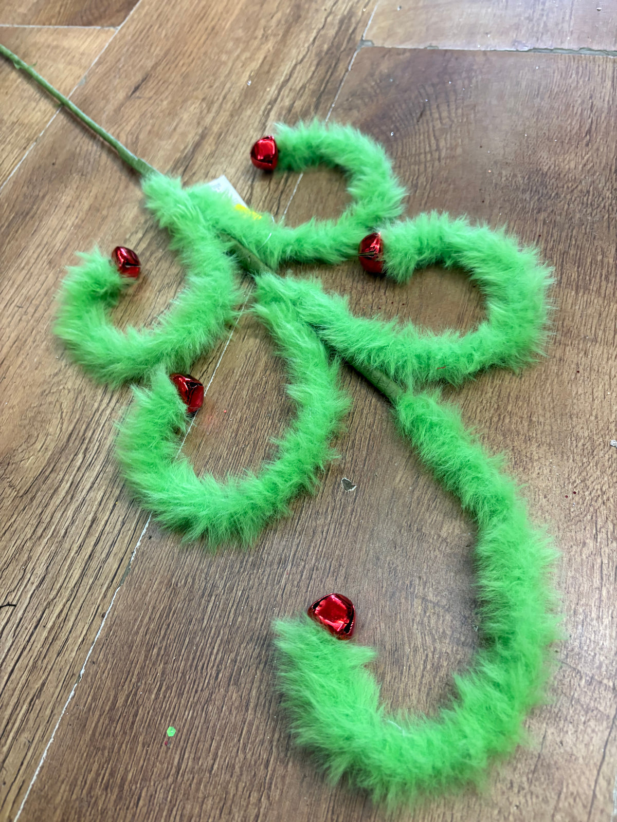 Fluffy green swirly stem with red bells