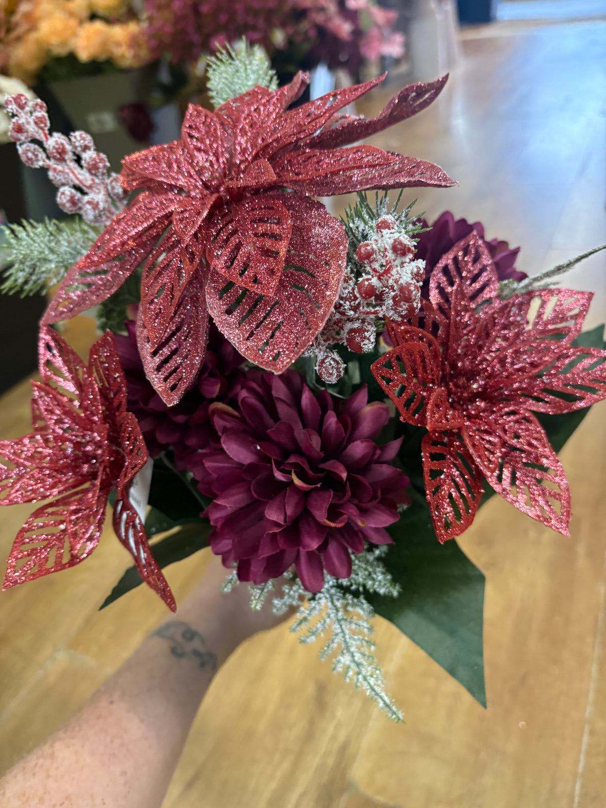 Pink glittered poinsettia and purple chrysanthemum bouquet