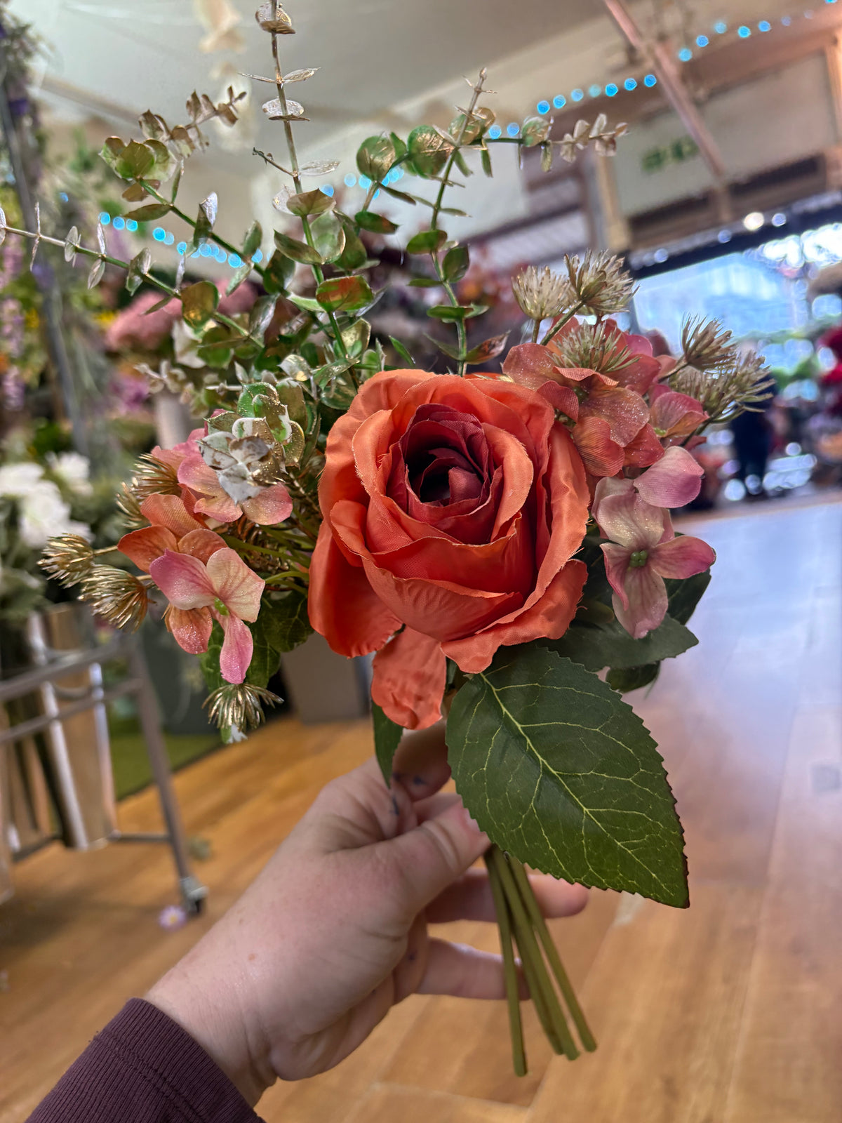 Hand tied bunch of mixed florals and gold shimmered foliage
