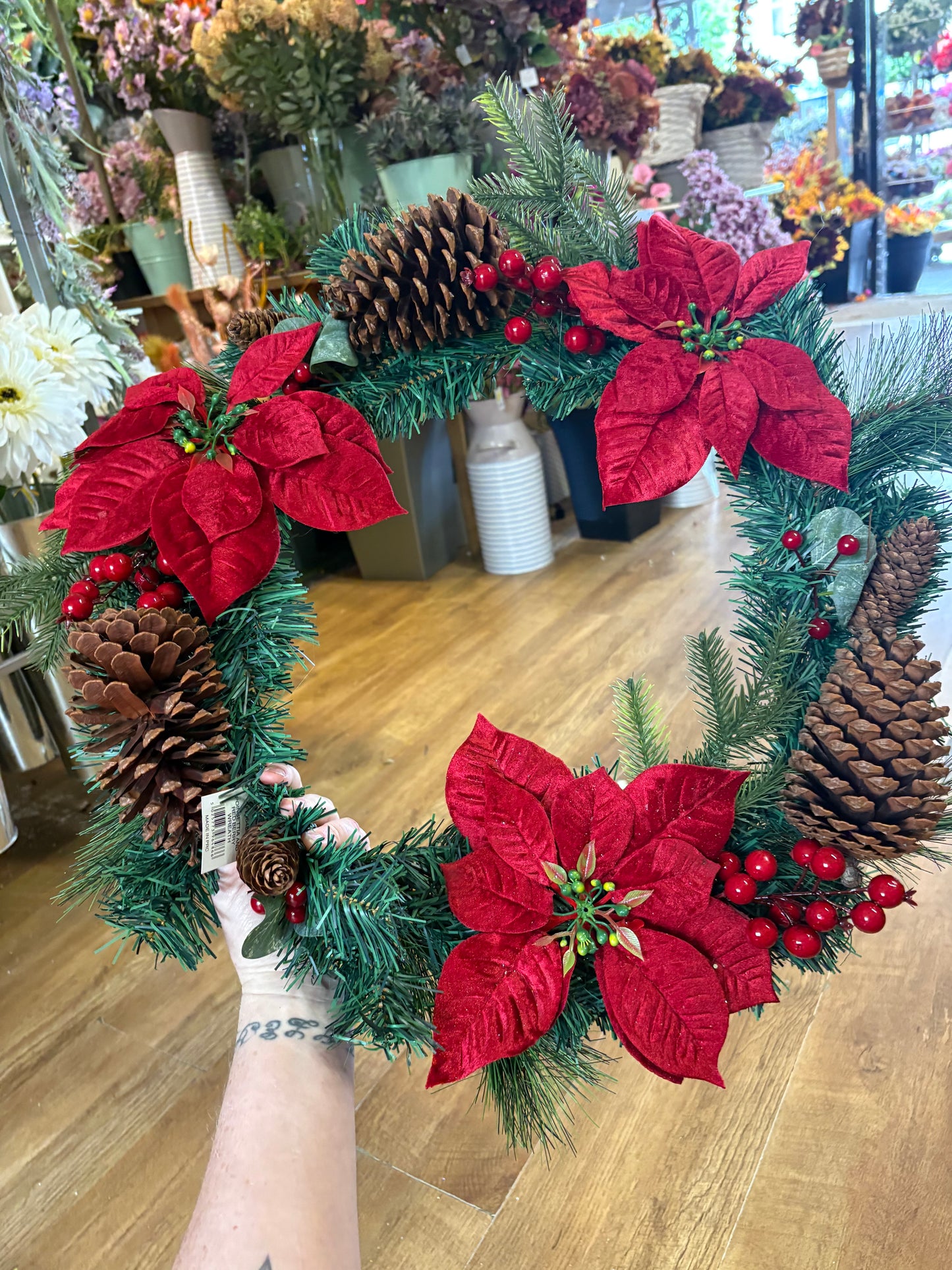 Poinsettia and red berry wreath (55cm from tip to tip)