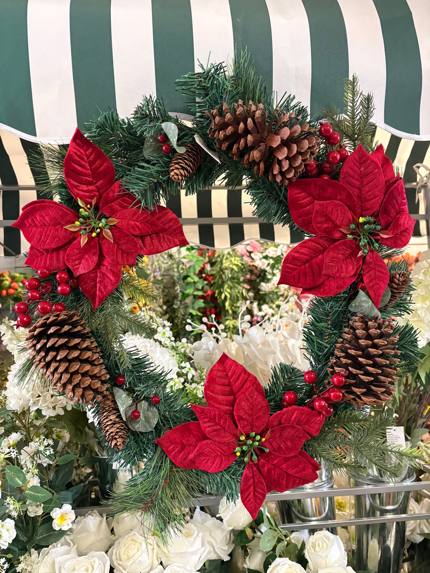 Poinsettia and red berry wreath (55cm from tip to tip)