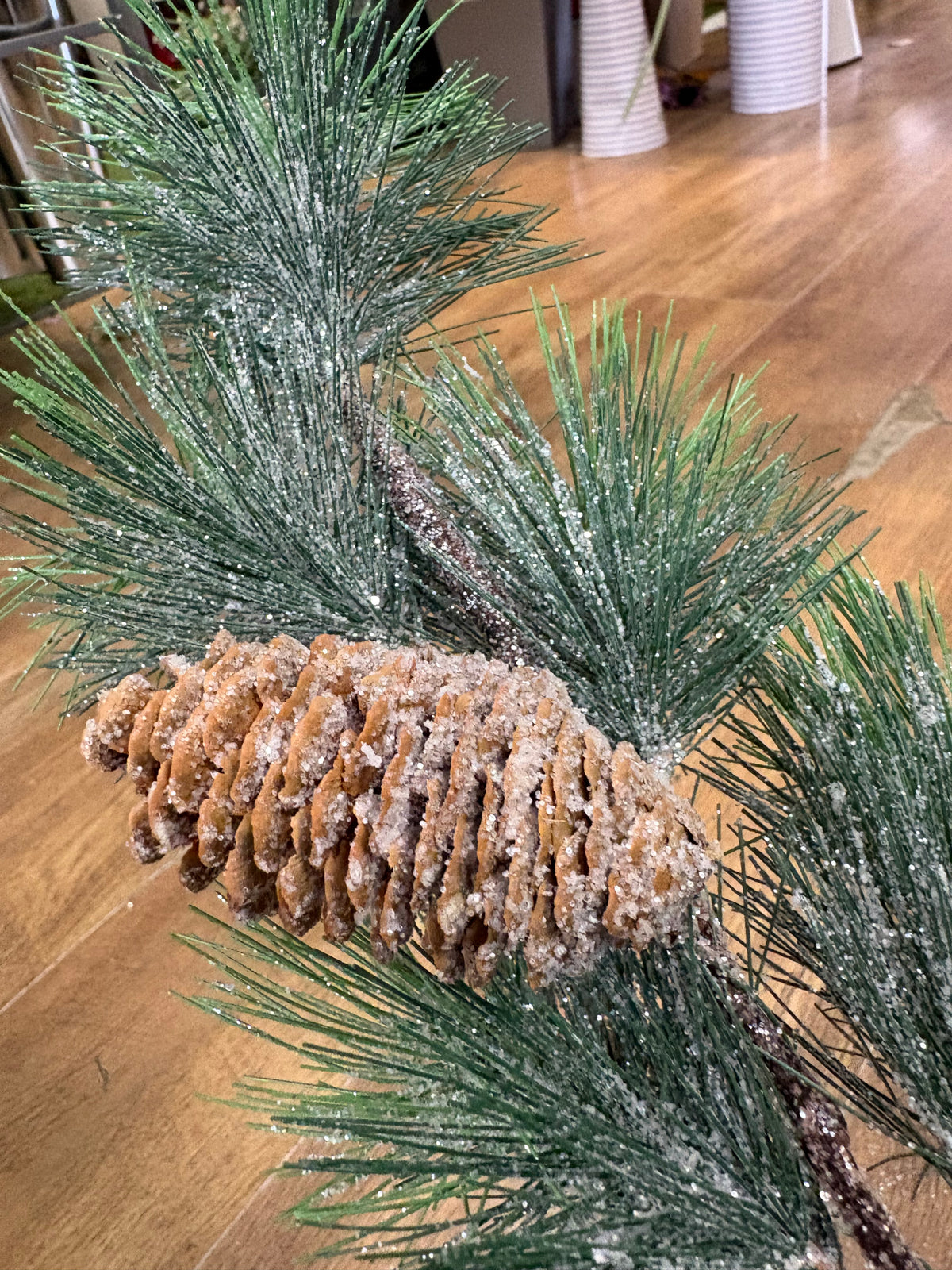 Long stem frosted and glittered winter foliage with cones