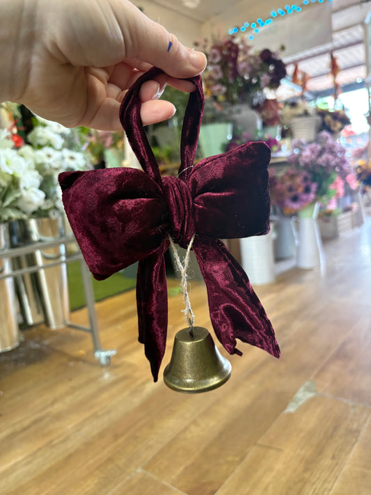Small hanging burgundy velvet bow and Christmas bell