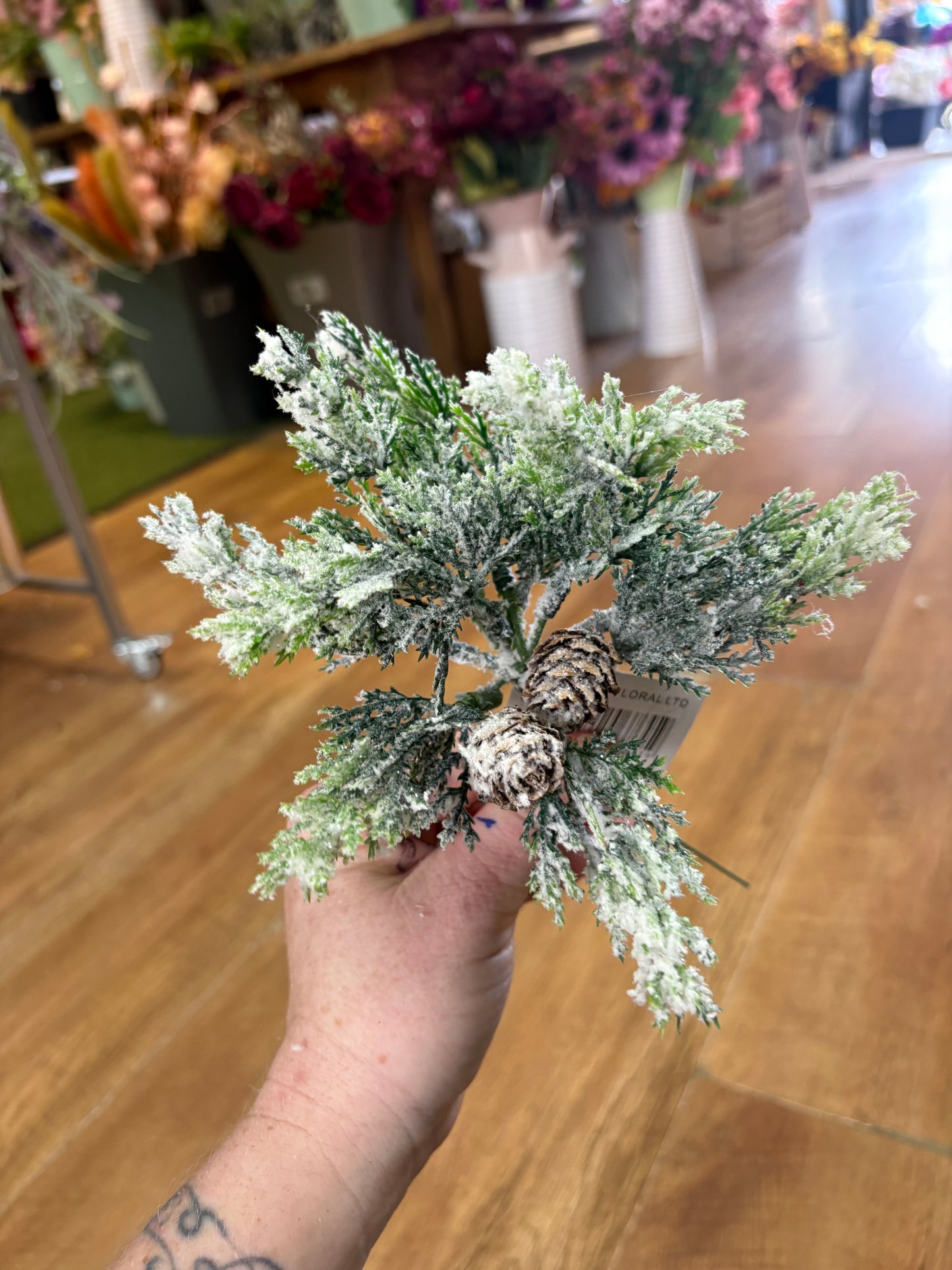 Small frosted foliage pick with miniature cones