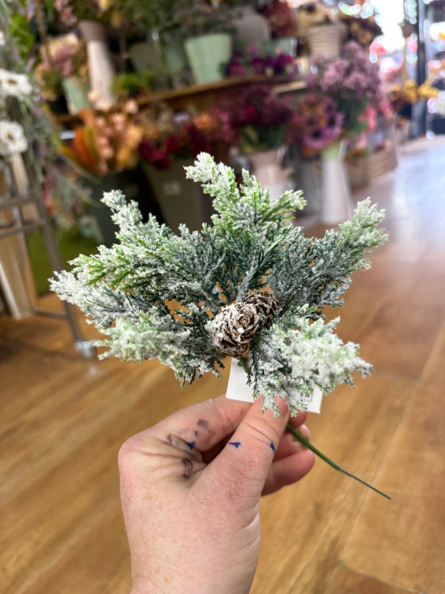 Small frosted foliage pick with miniature cones