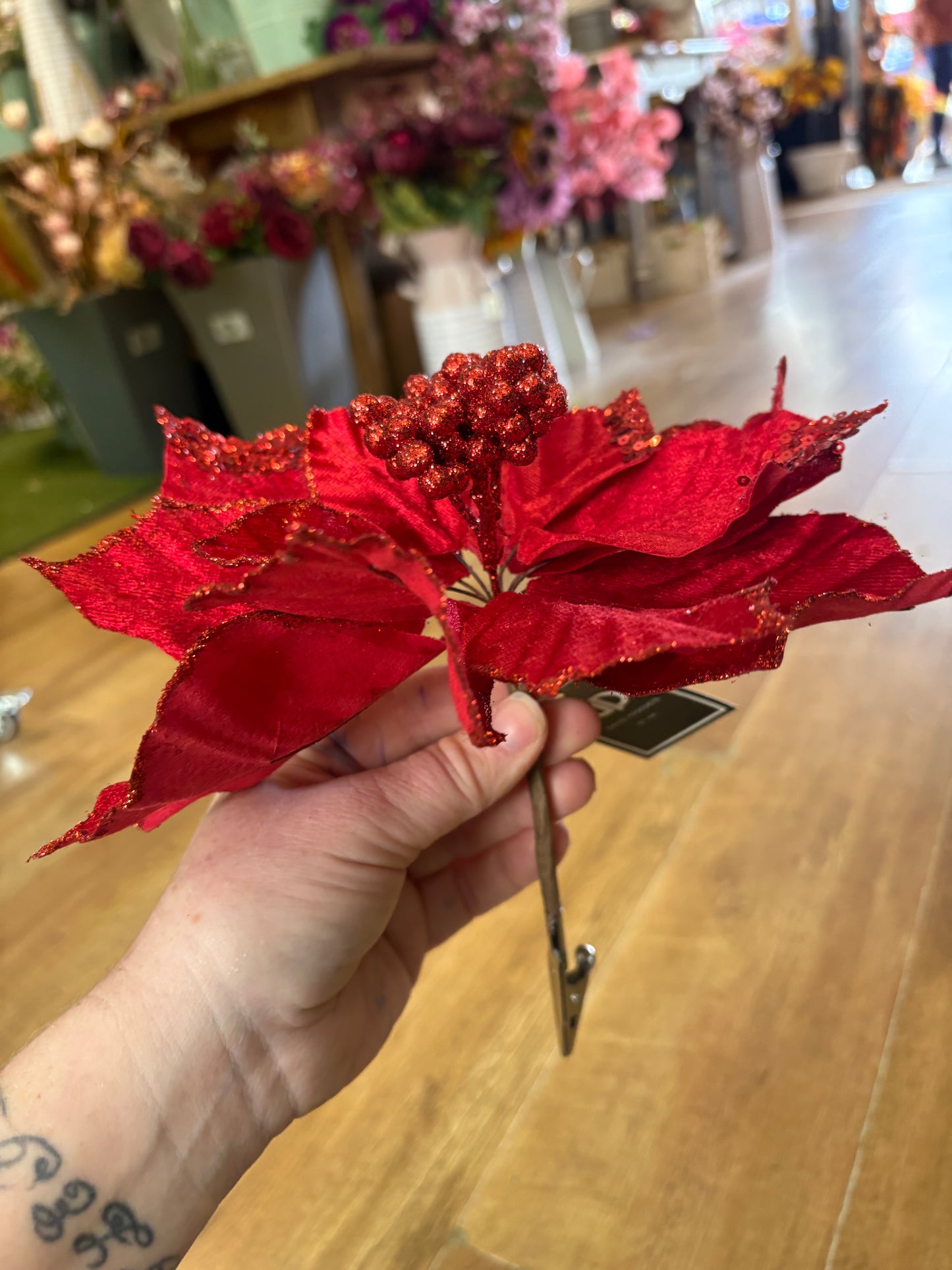 Clip on red velvet and glittered poinsettia