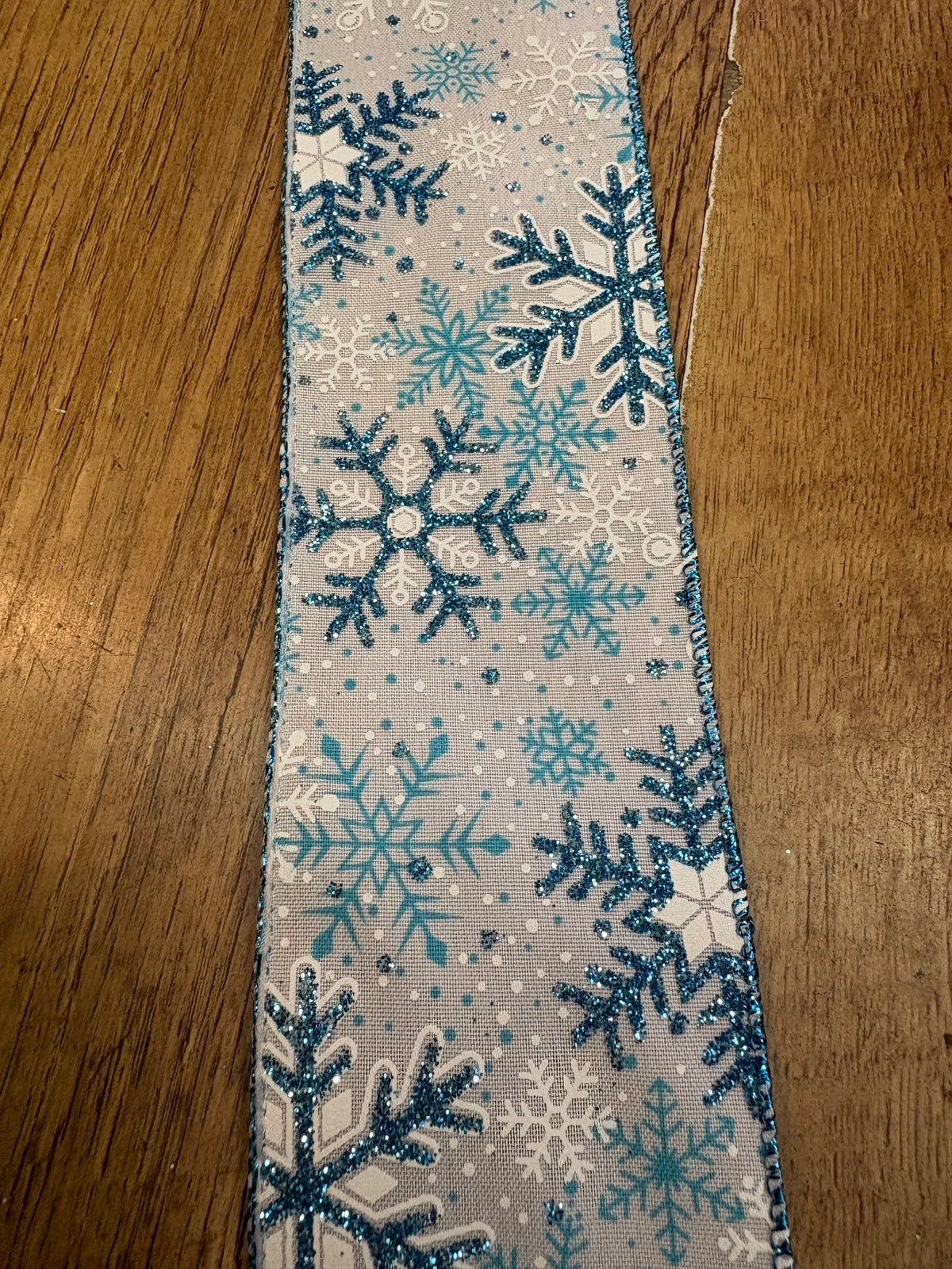 2.5 inch wide glittered blue and white snowflake wired ribbon - 1 metre