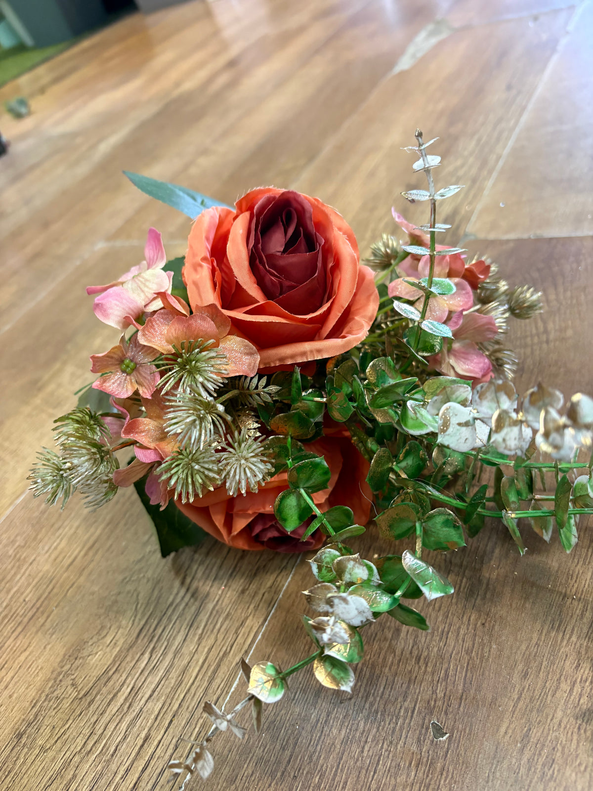 Hand tied bunch of mixed florals and gold shimmered foliage