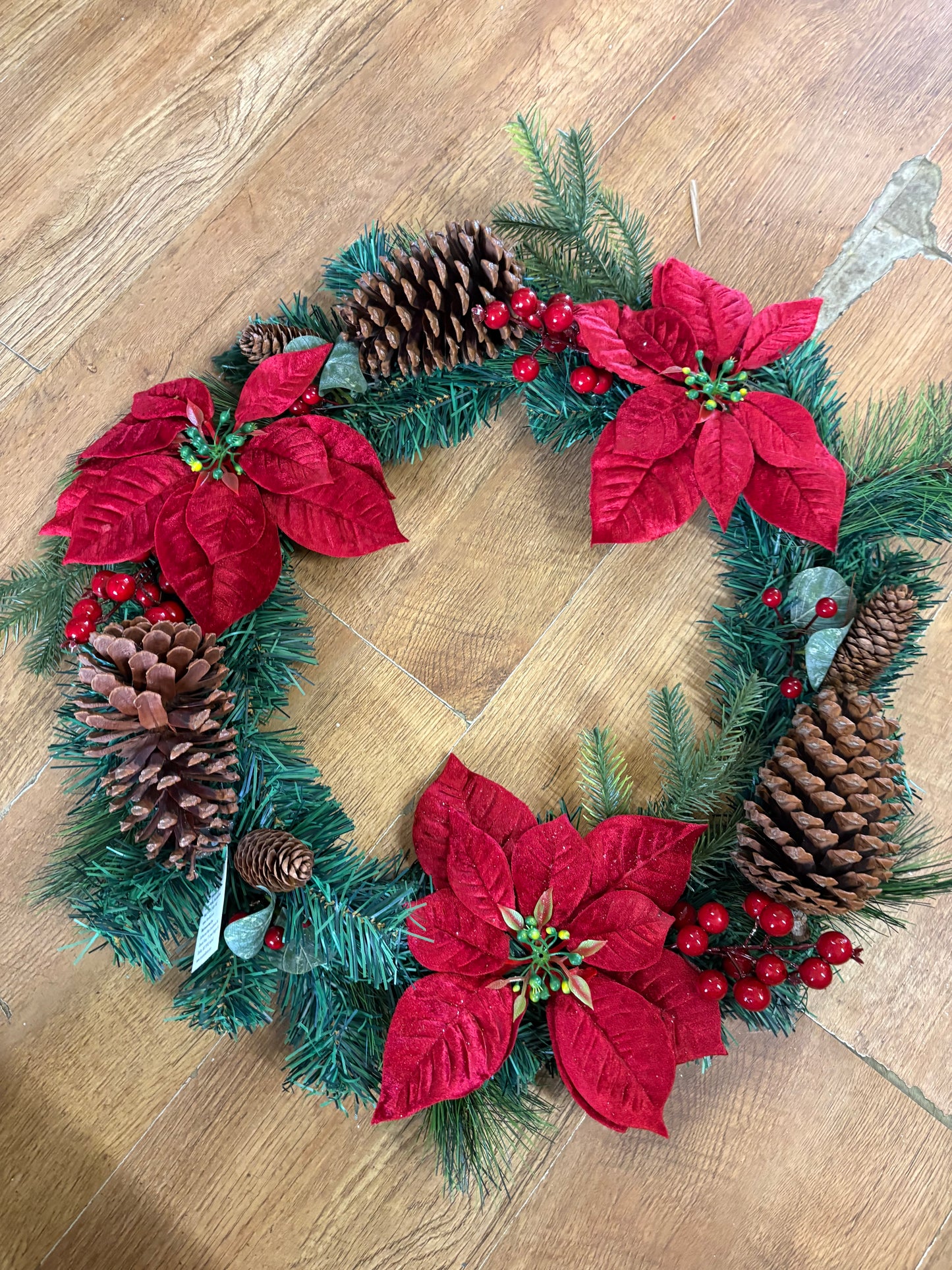 Poinsettia and red berry wreath (55cm from tip to tip)