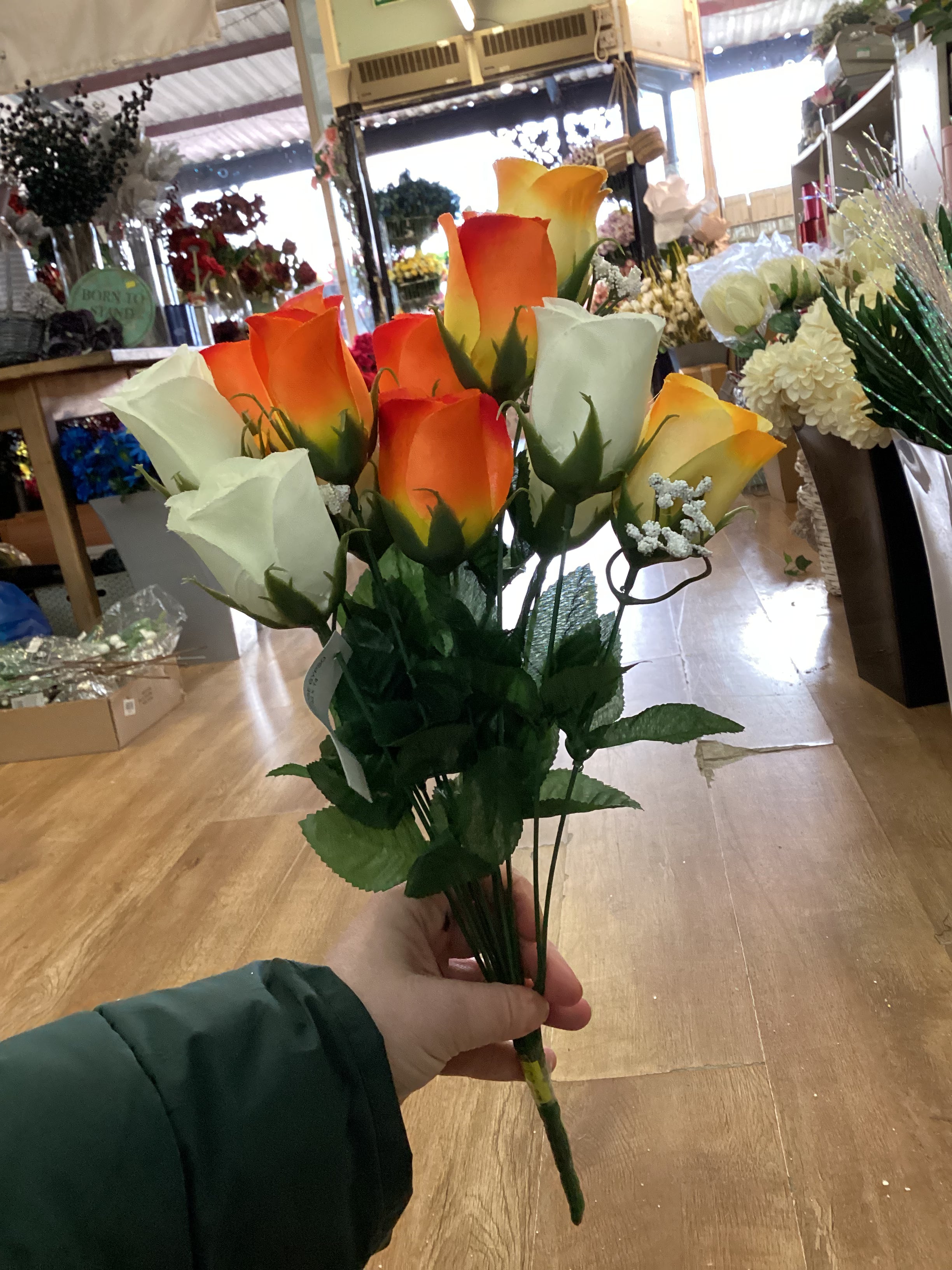 Big bunch of orange, yellow and ivory roses and gypsophila