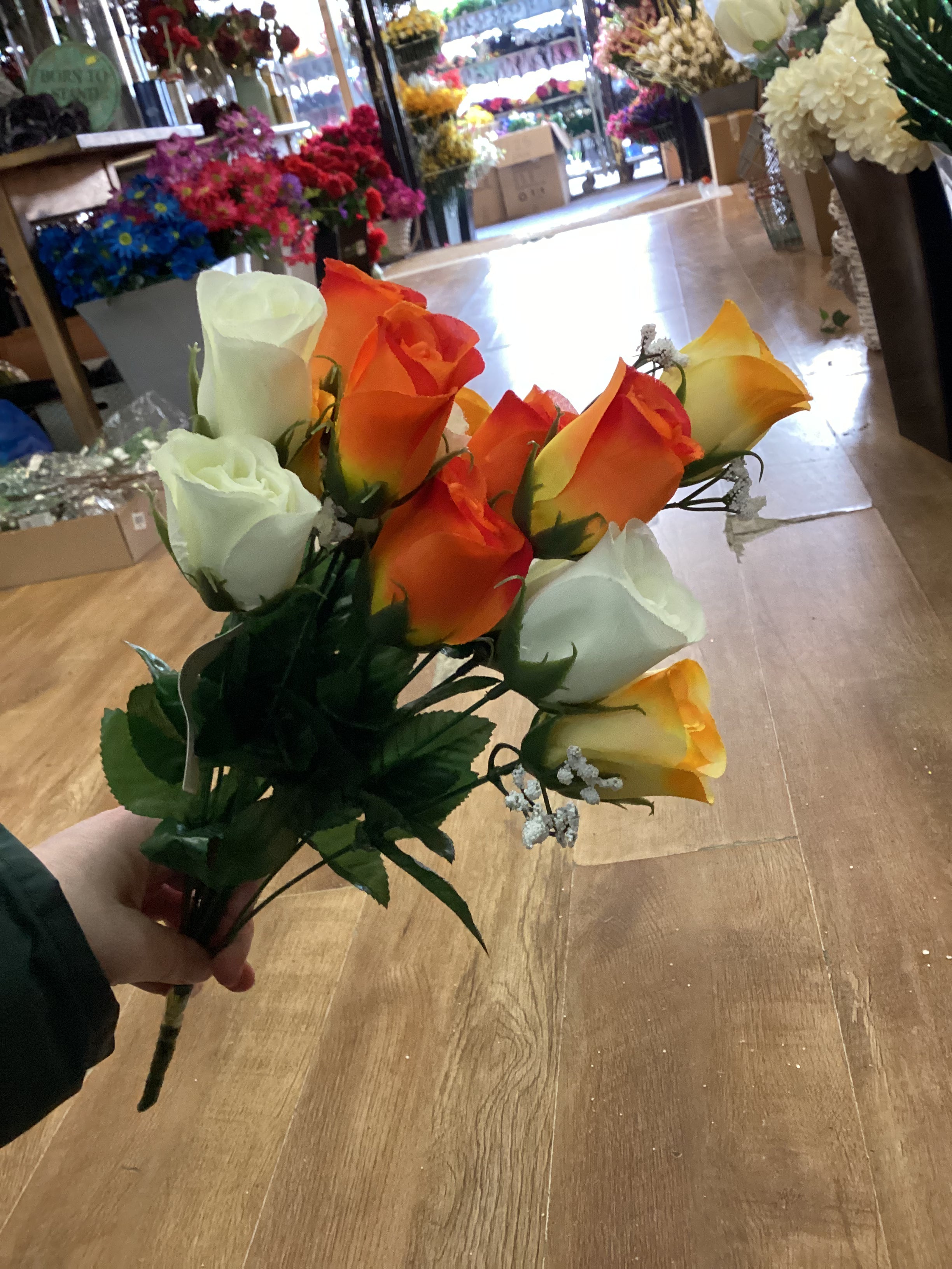 Big bunch of orange, yellow and ivory roses and gypsophila