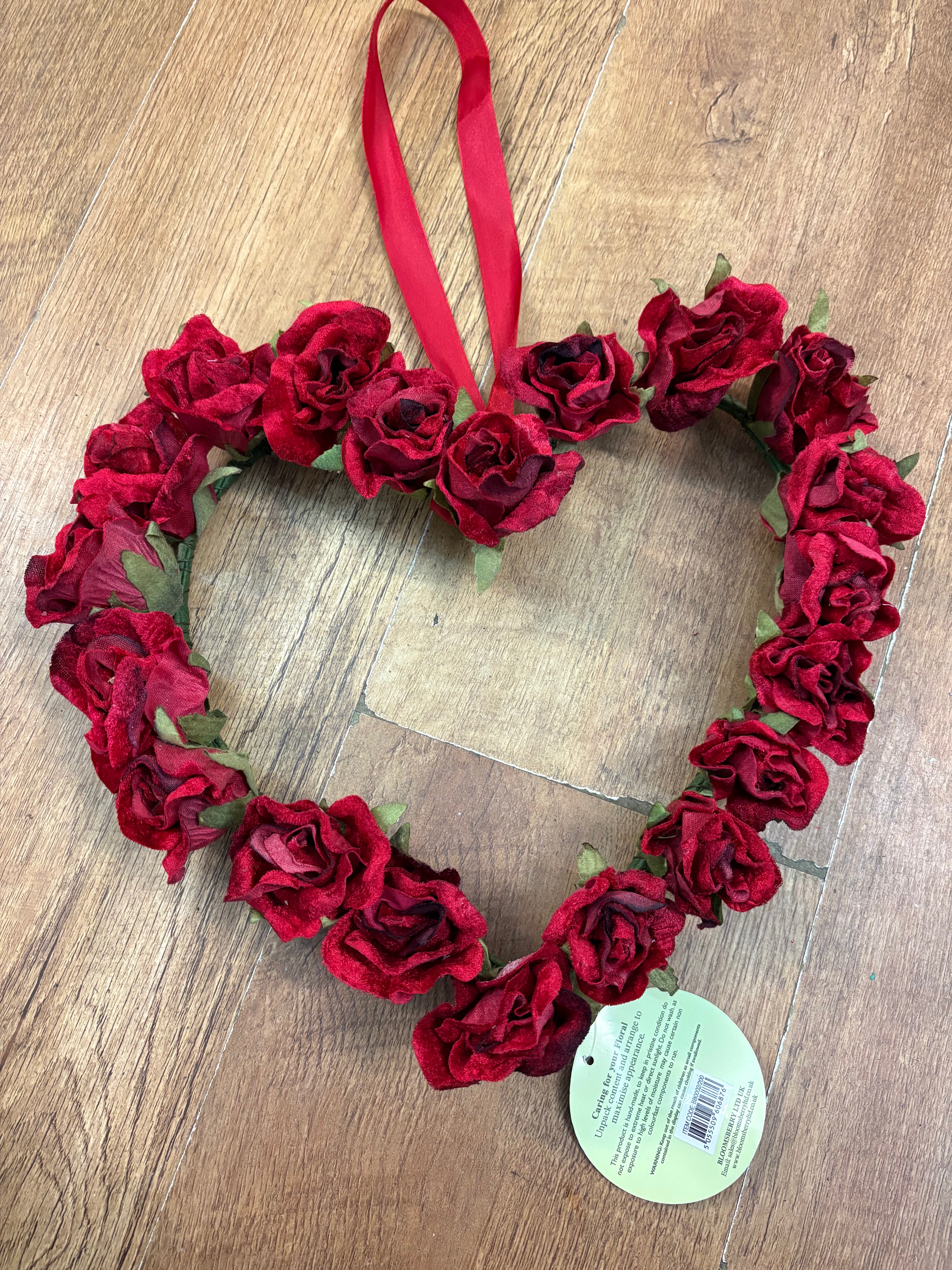 Red velvet rose heart wreath with hanging red ribbon