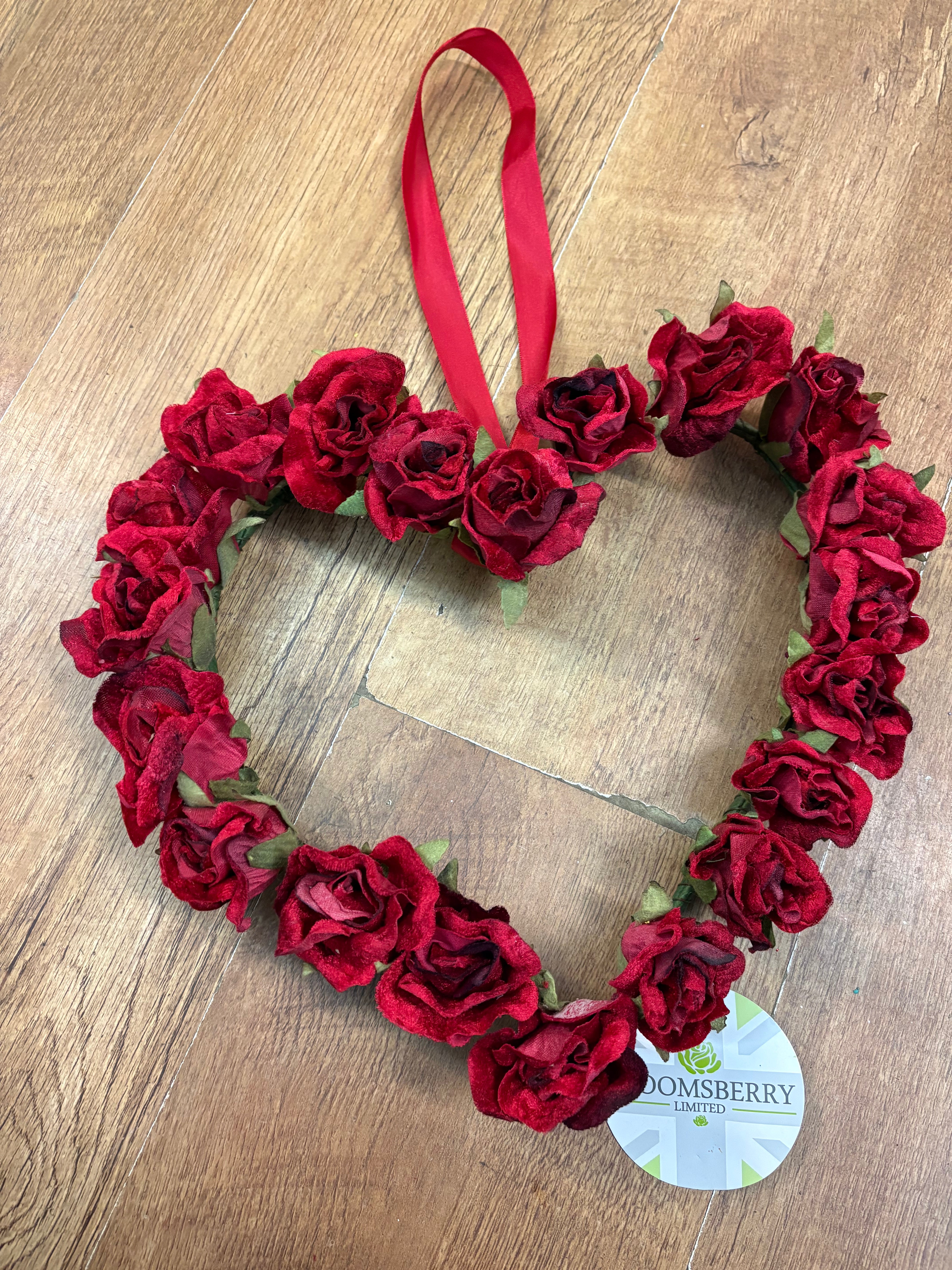 Red velvet rose heart wreath with hanging red ribbon