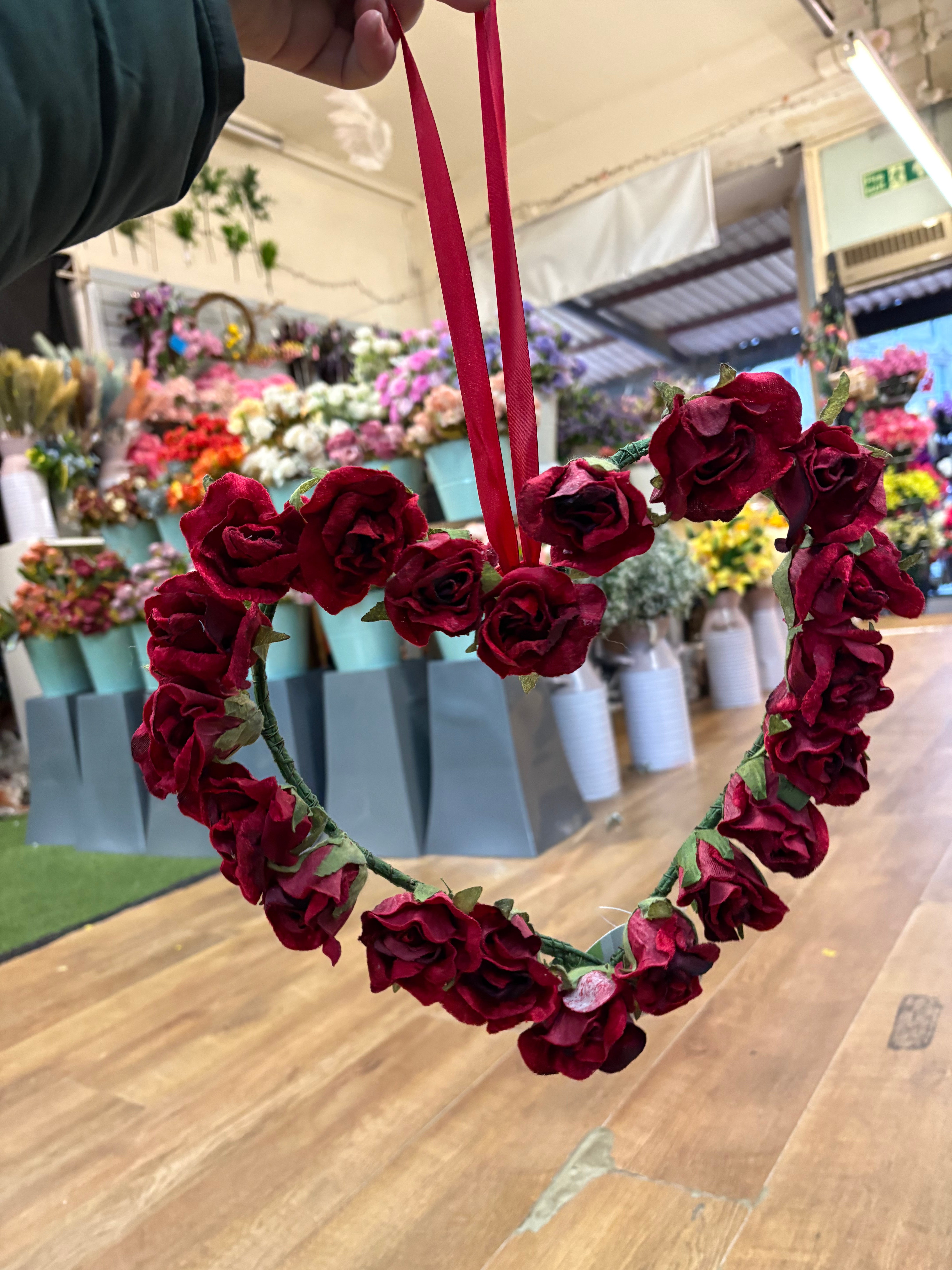 Red velvet rose heart wreath with hanging red ribbon
