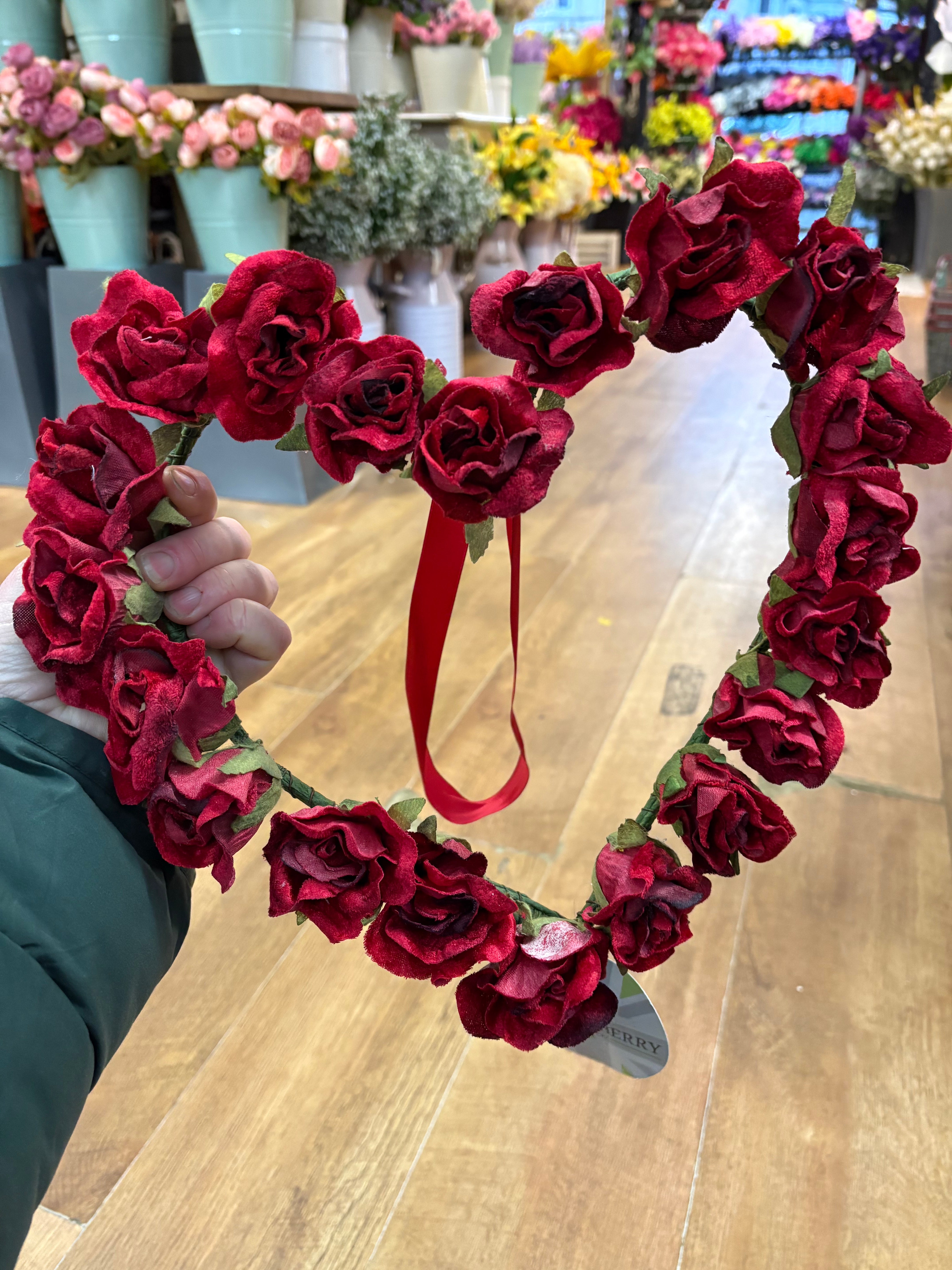 Red velvet rose heart wreath with hanging red ribbon