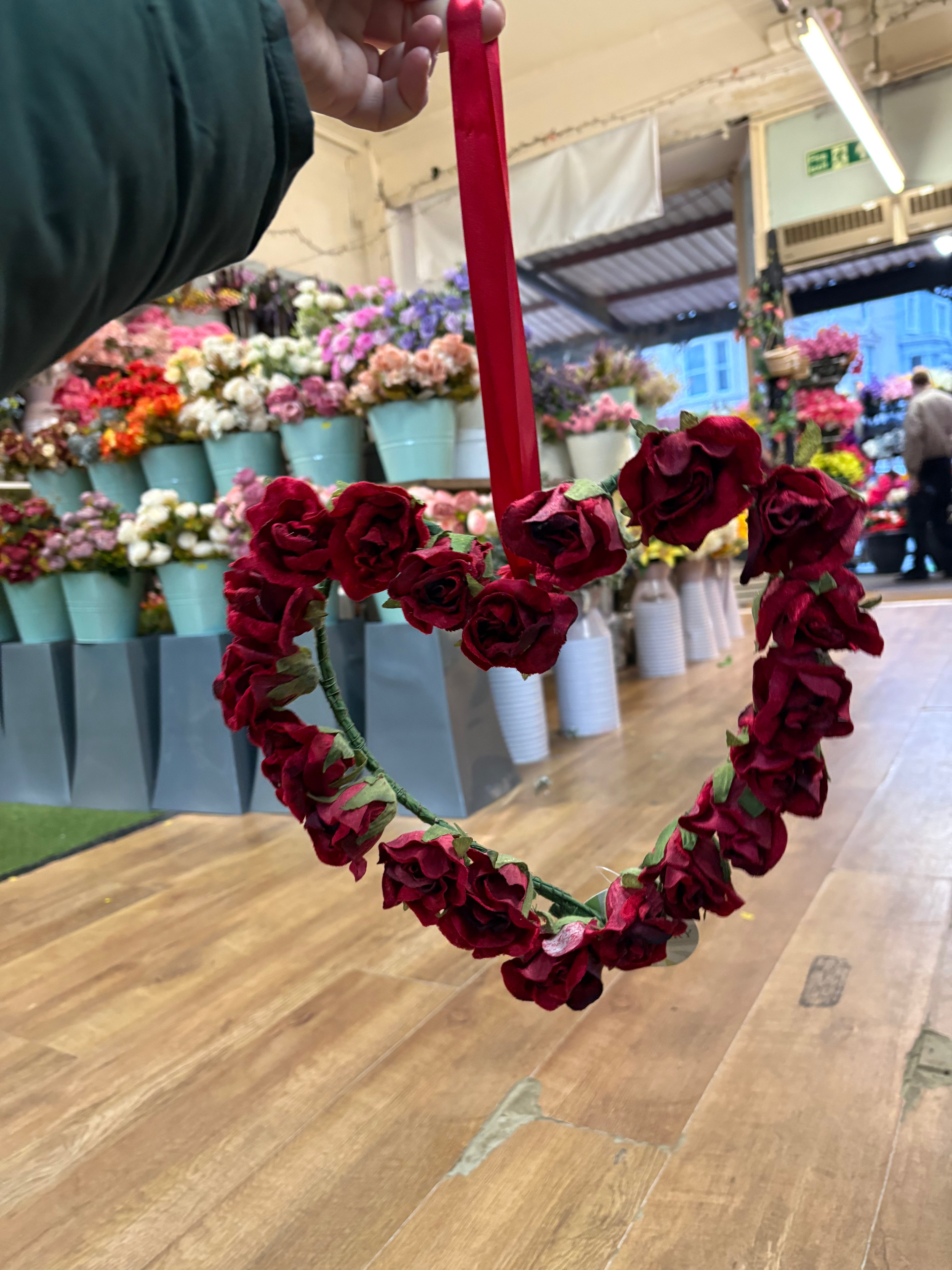 Red velvet rose heart wreath with hanging red ribbon