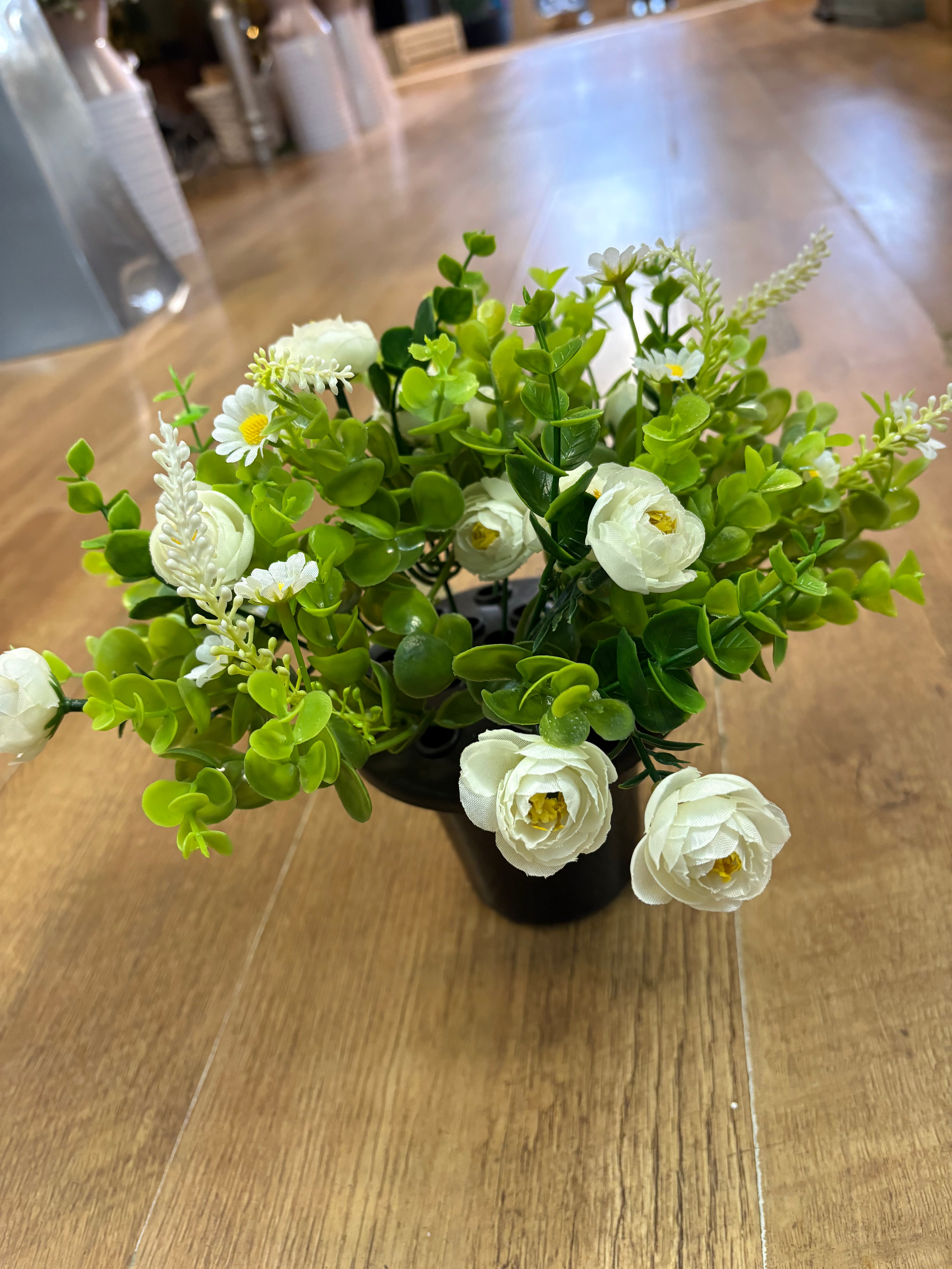 Ivory mini ranunculus and eucalyptus gravepot