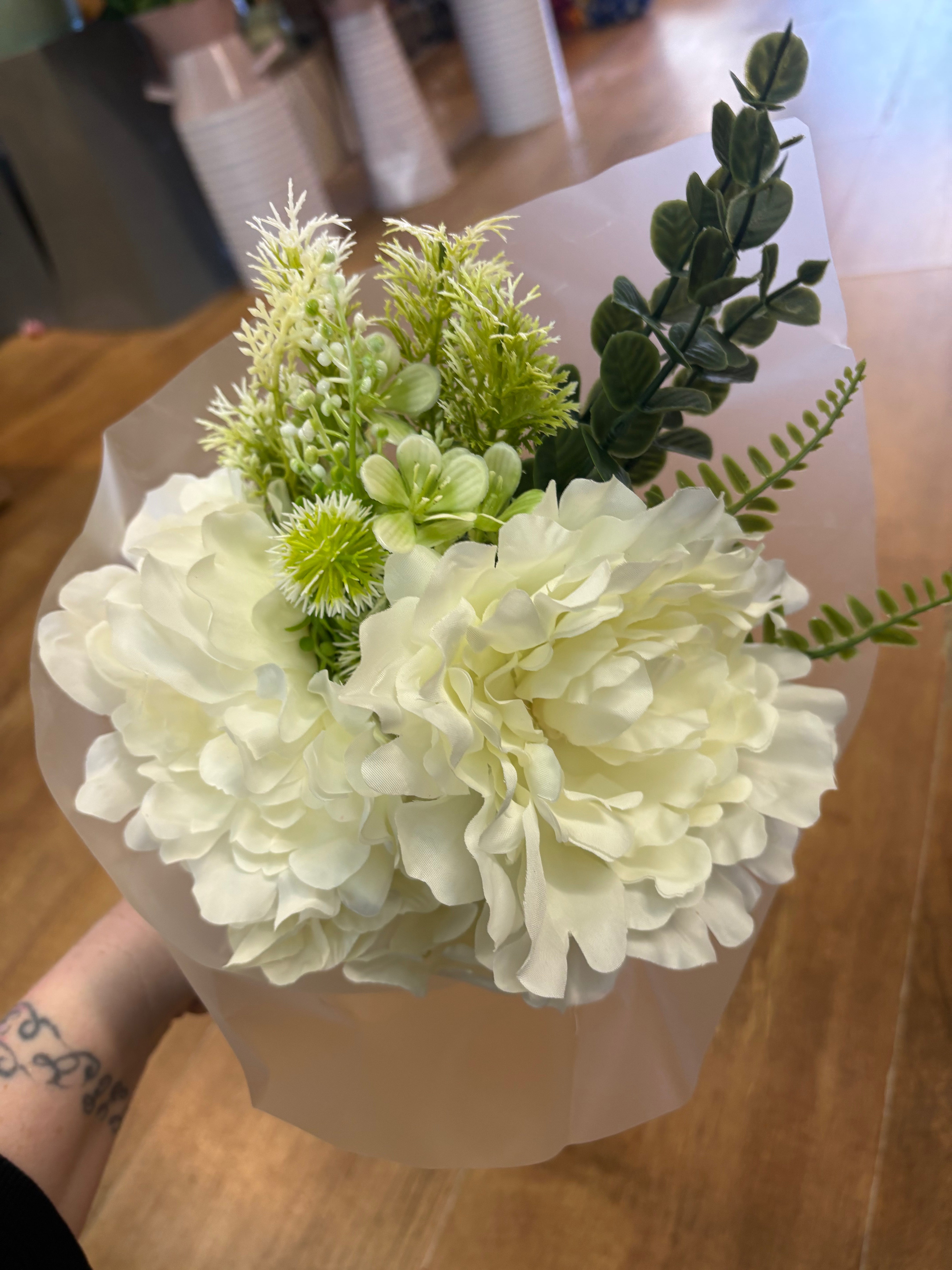 Small wrapped ivory peony and mixed foliage bouquet