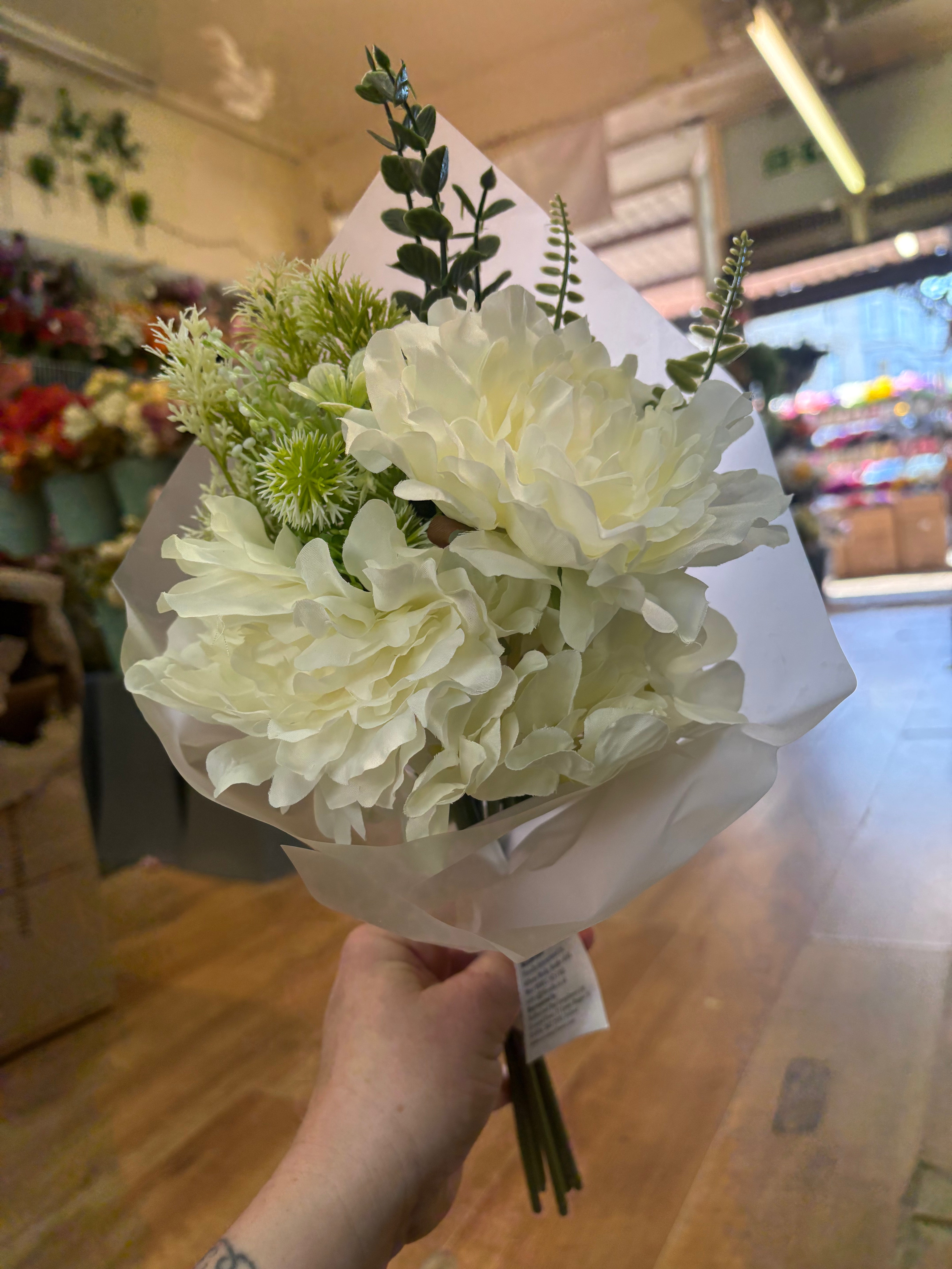Small wrapped ivory peony and mixed foliage bouquet