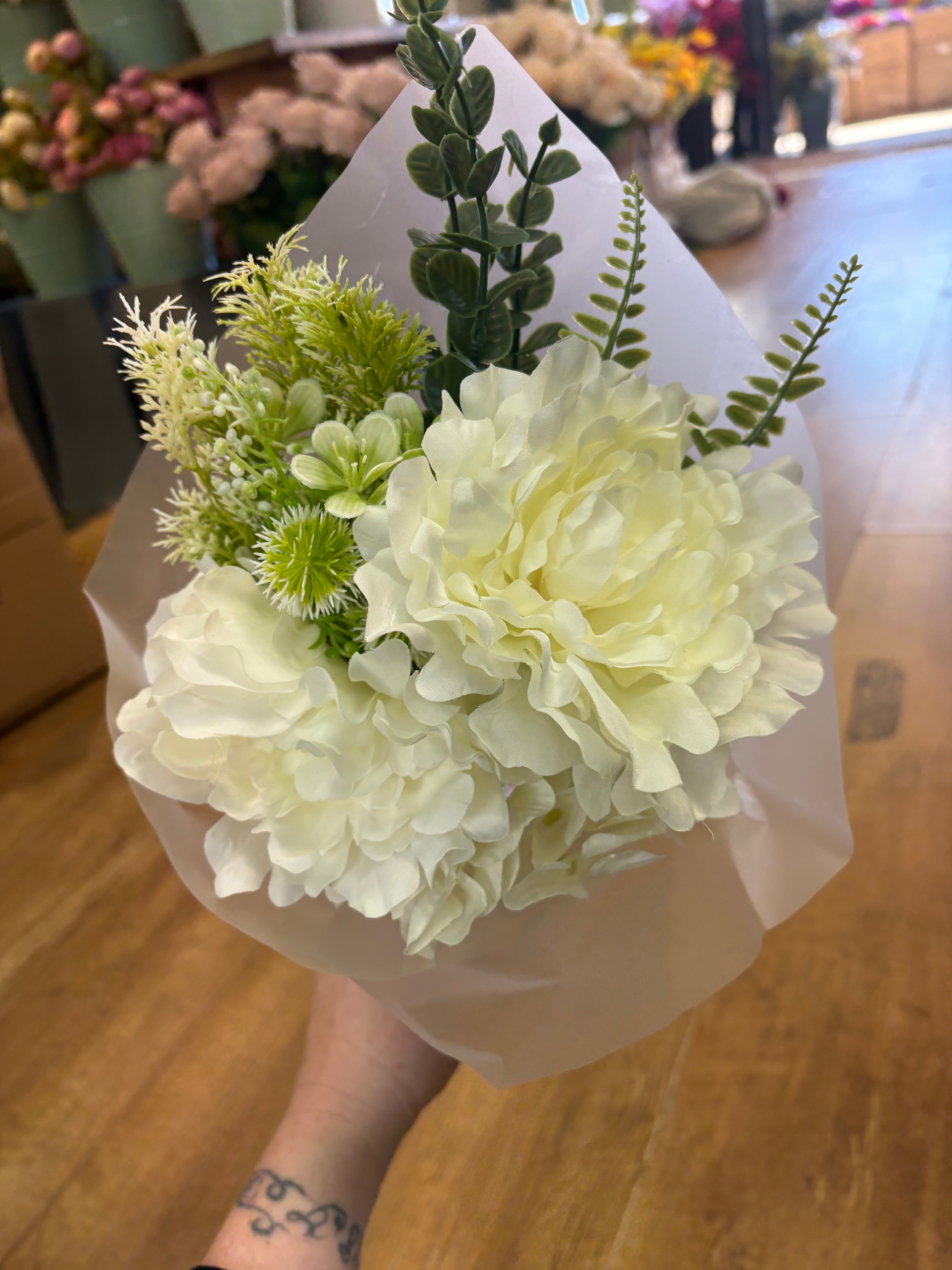 Small wrapped ivory peony and mixed foliage bouquet