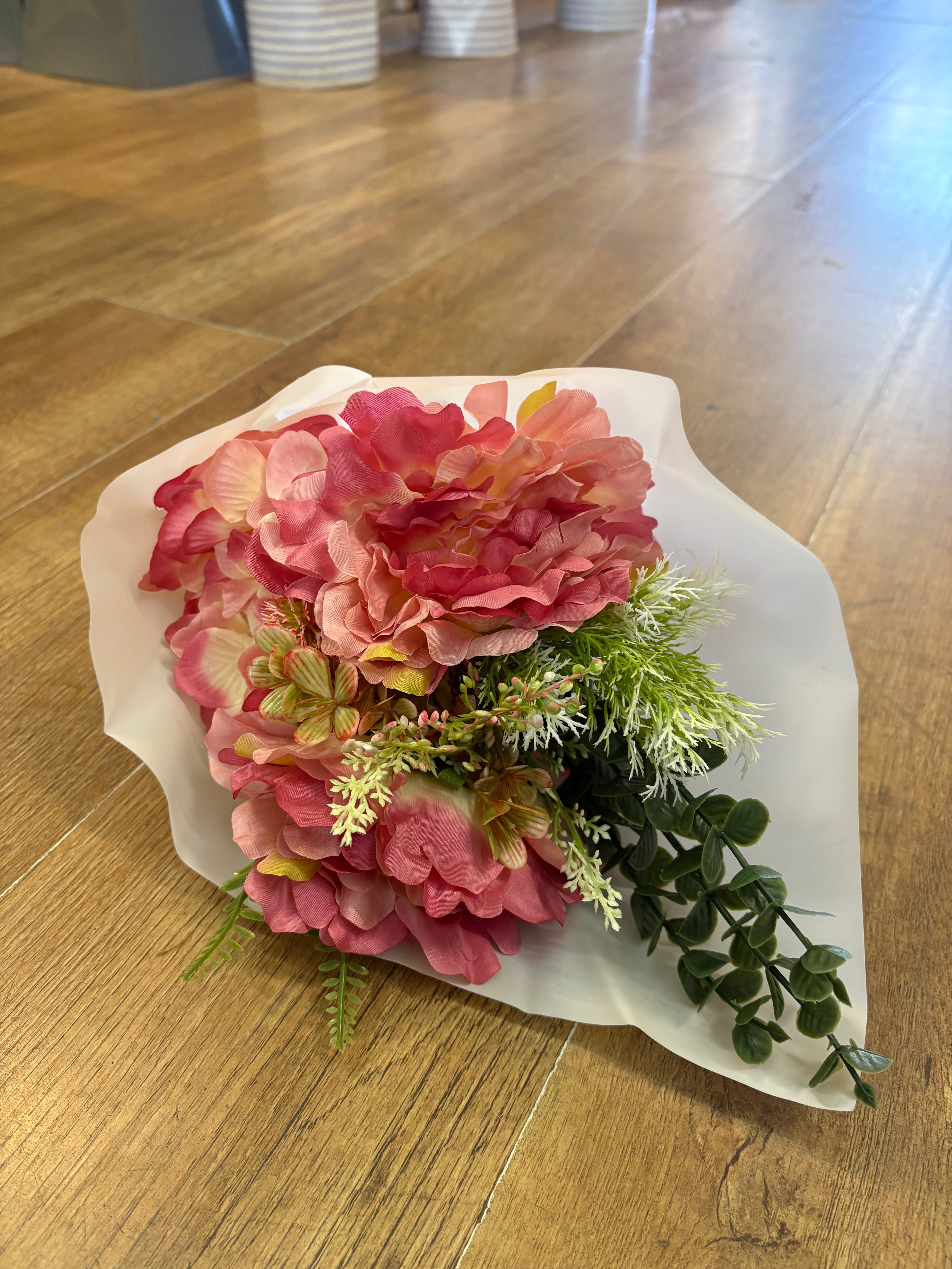 Small wrapped pink peony and mixed foliage bouquet