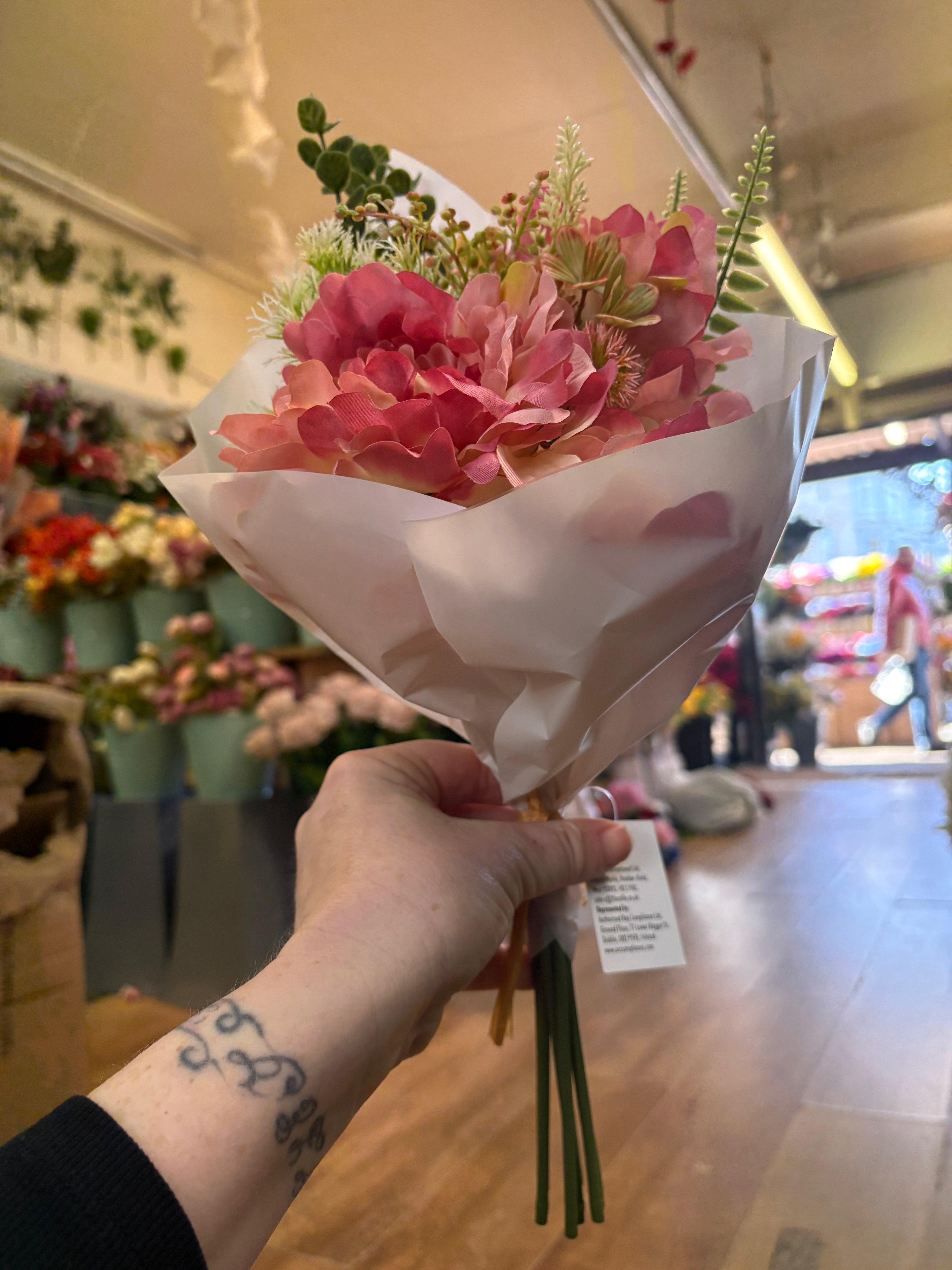 Small wrapped pink peony and mixed foliage bouquet