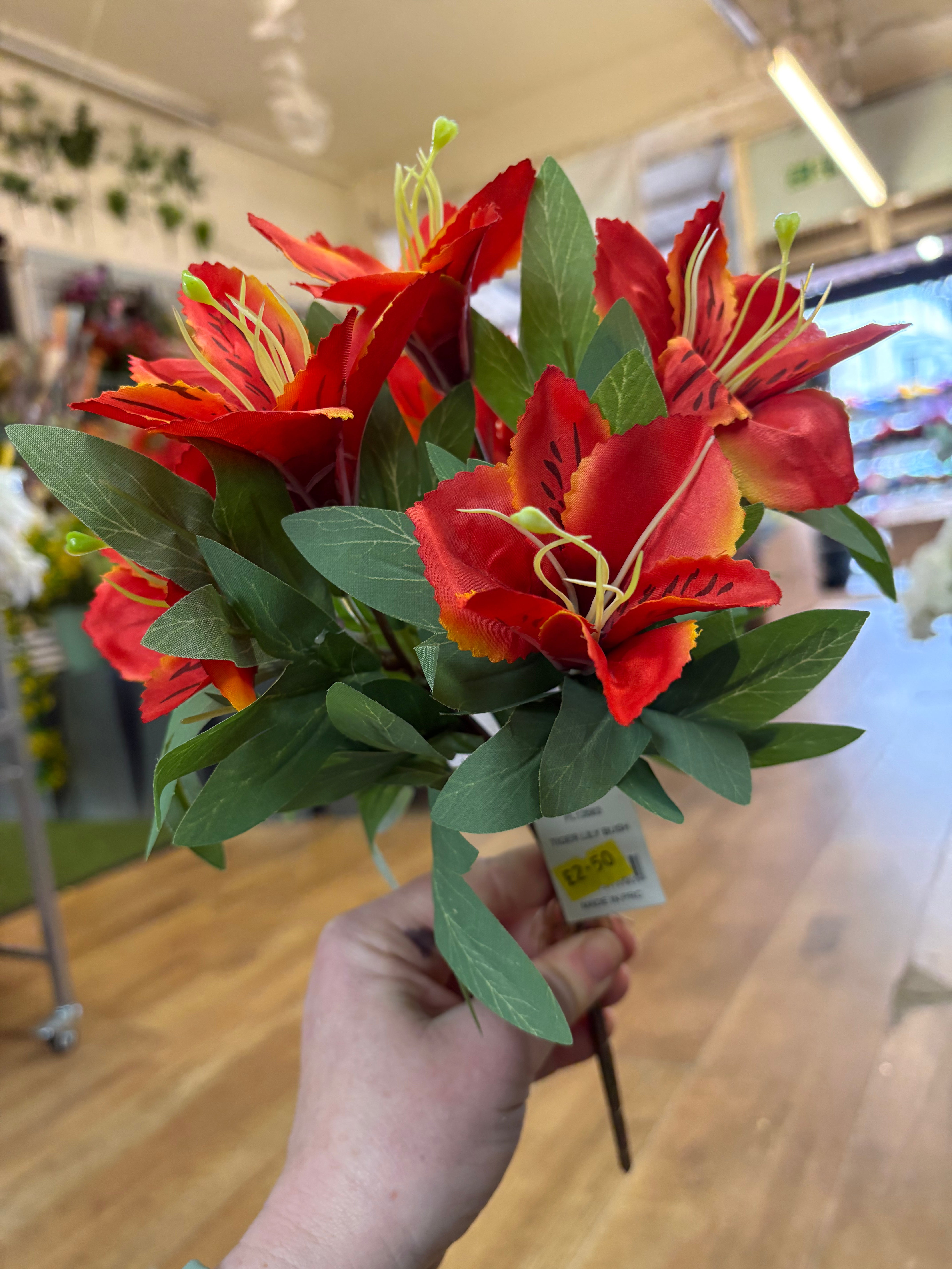 Orange tiger lily and foliage bush