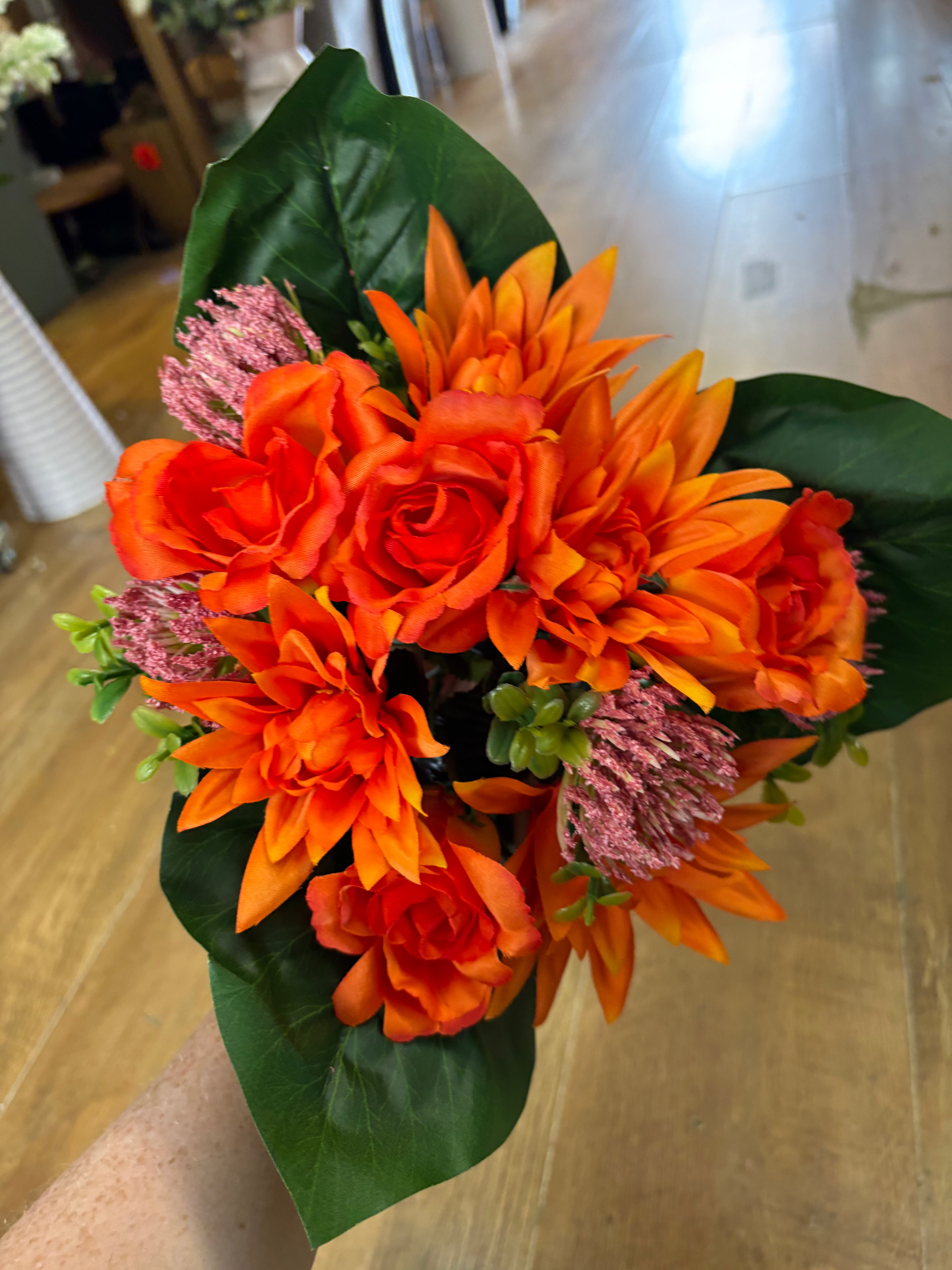 Orange dahlia, rose and flocked protea bouquet