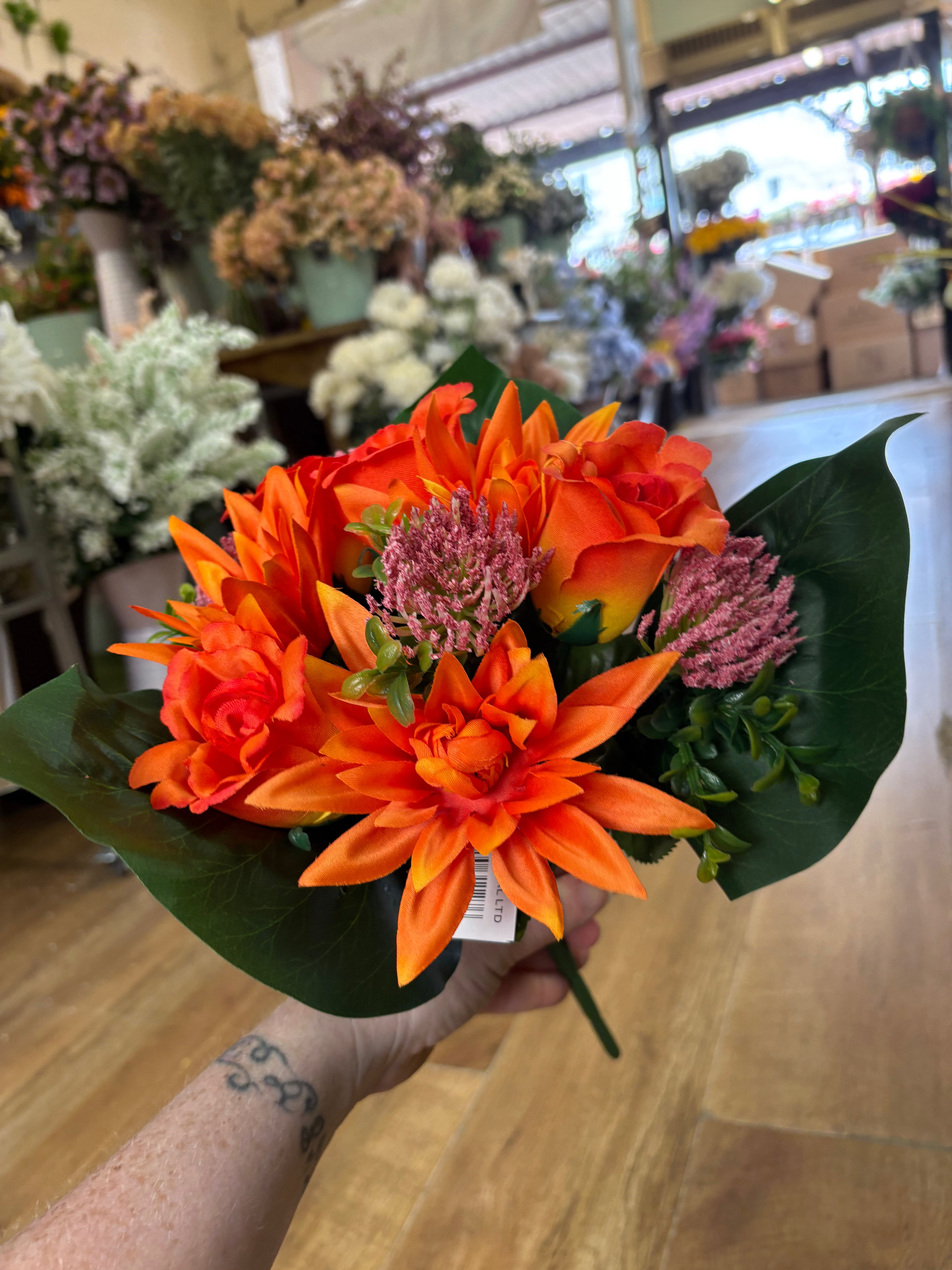 Orange dahlia, rose and flocked protea bouquet