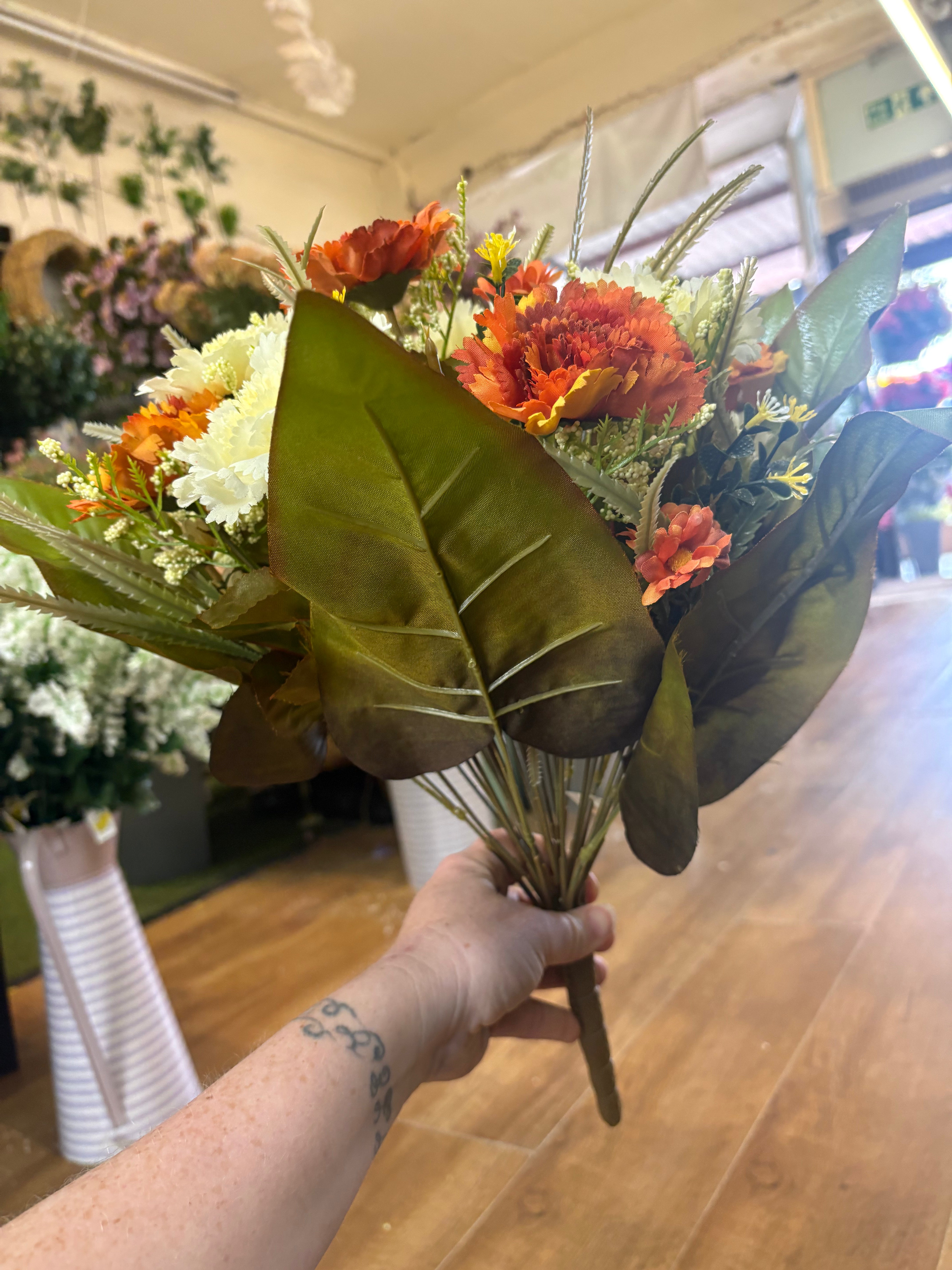 Large burnt orange and cream carnation and mixed foliage Bouquet