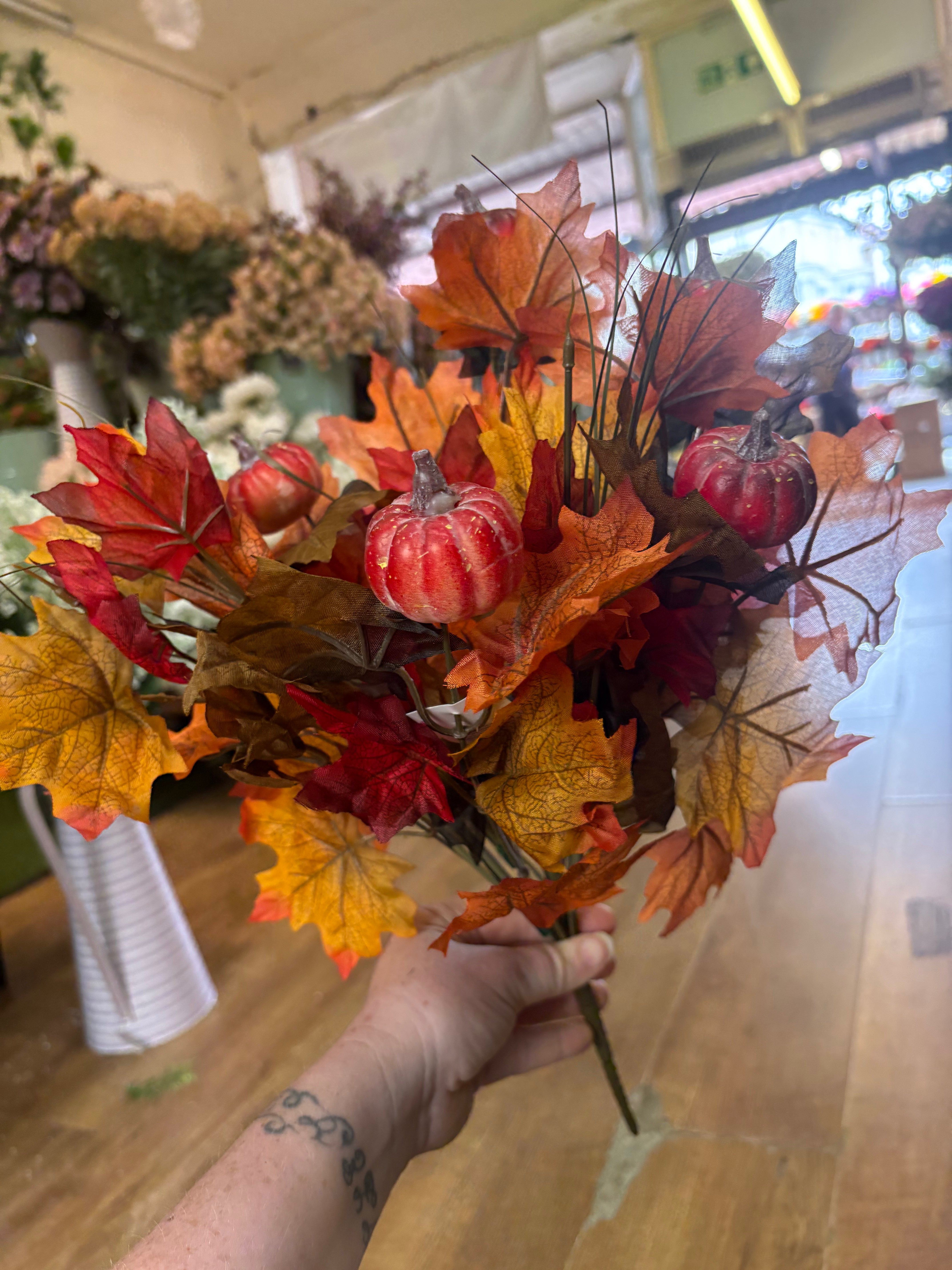 Large autumn leaves and orange pumpkins bunch