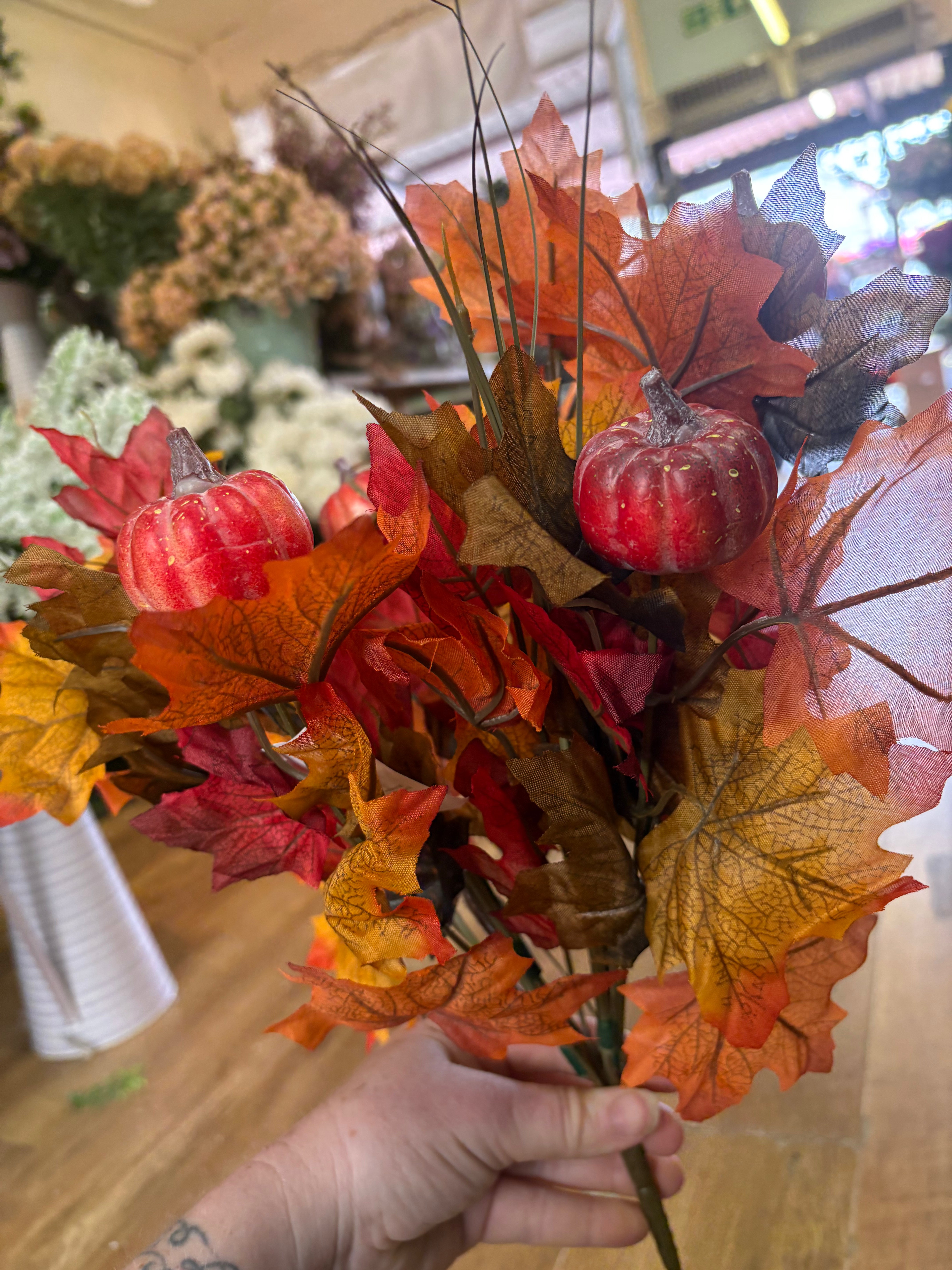 Large autumn leaves and orange pumpkins bunch